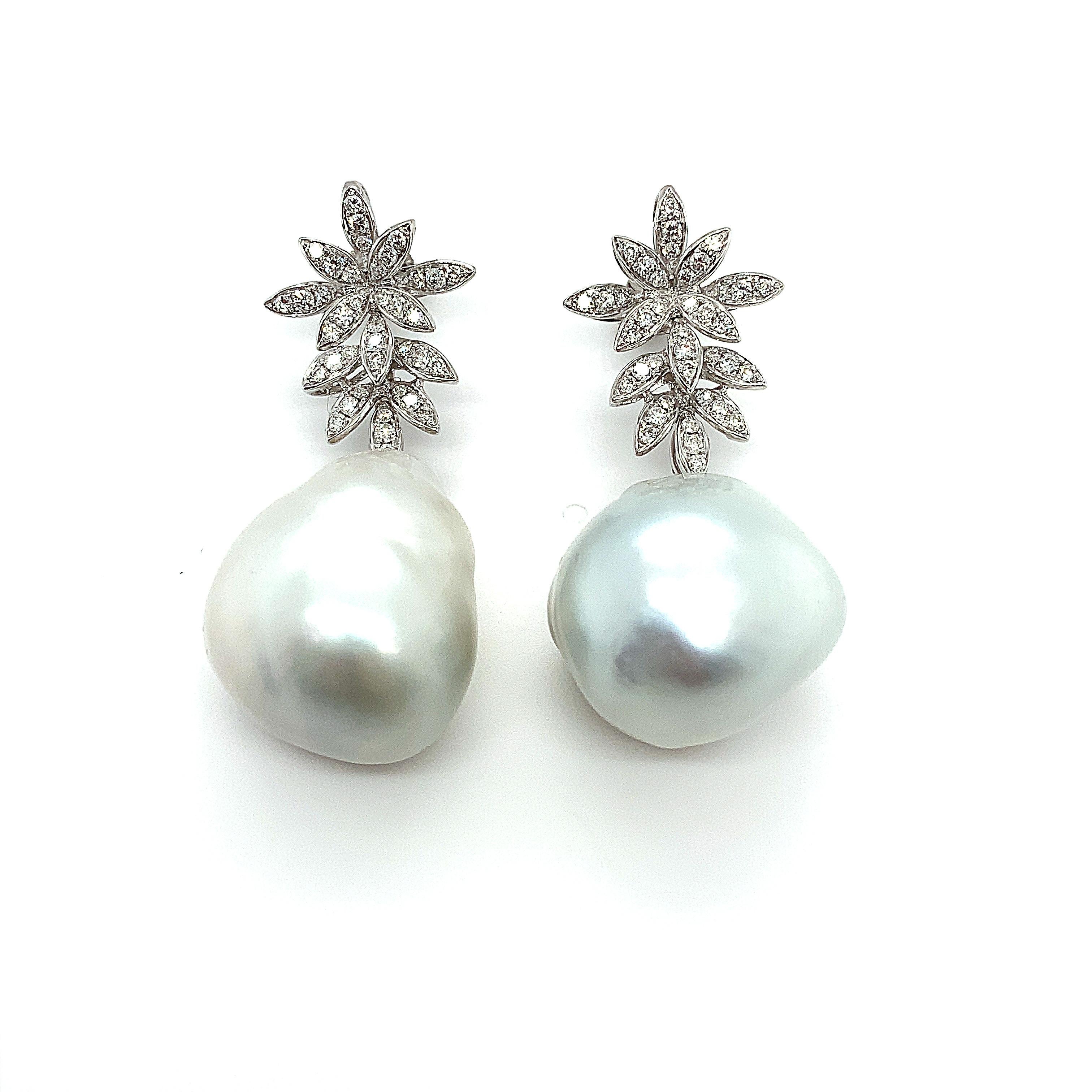 Magnificent pair of one such piece of drop shaped natural pearl and round brilliant diamonds  in 18K white gold.
The two pearls are slightly differ in shape and the size as the left pearl appears to be slightly longer in length than the right one,