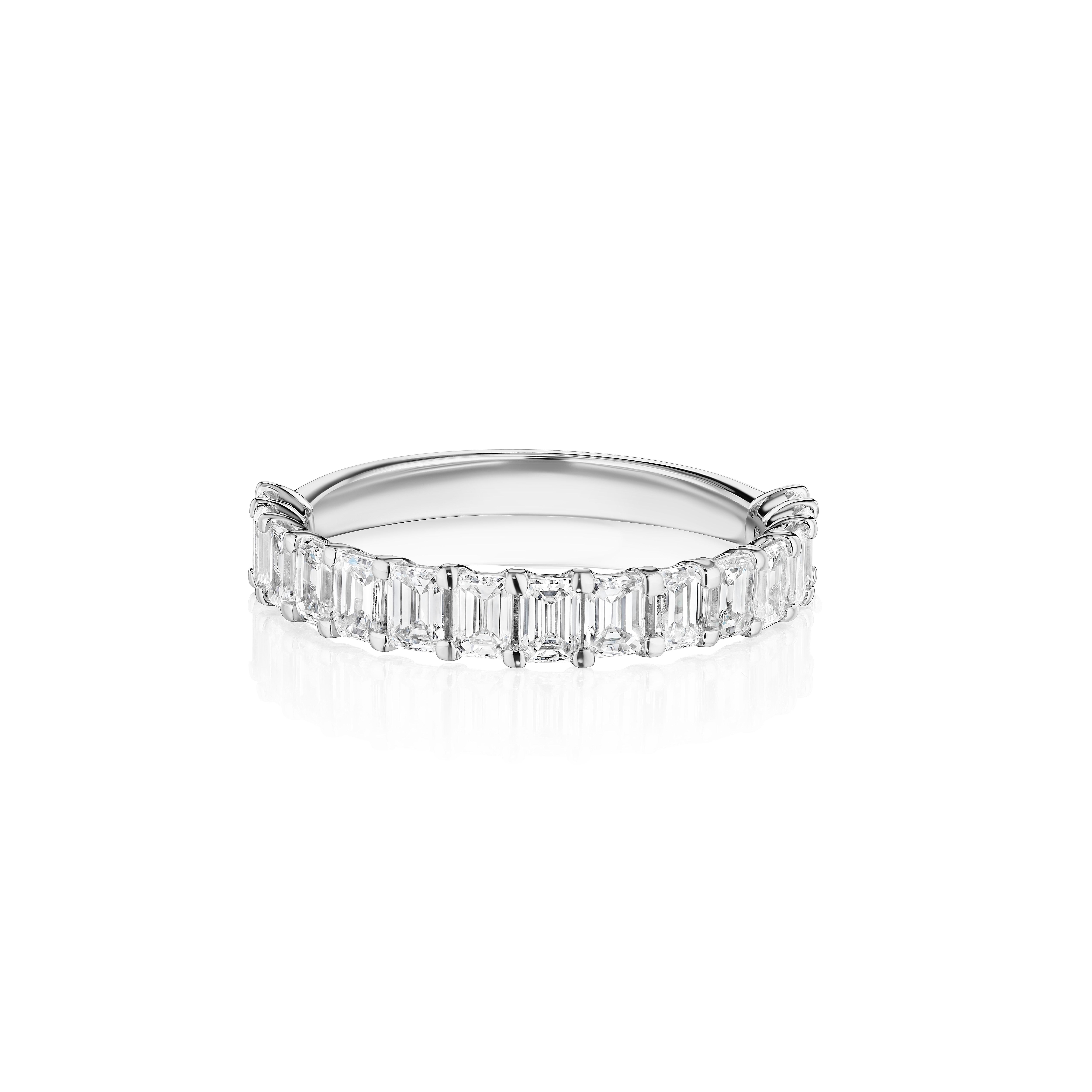 •	Crafted in 18KT gold, this band is made with 15 emerald cut diamonds, and has a combining total weight of approximately 1.50 carats. The diamonds are set in a shared prong cup setting and extend halfway down the band.  Worn beautifully on its own