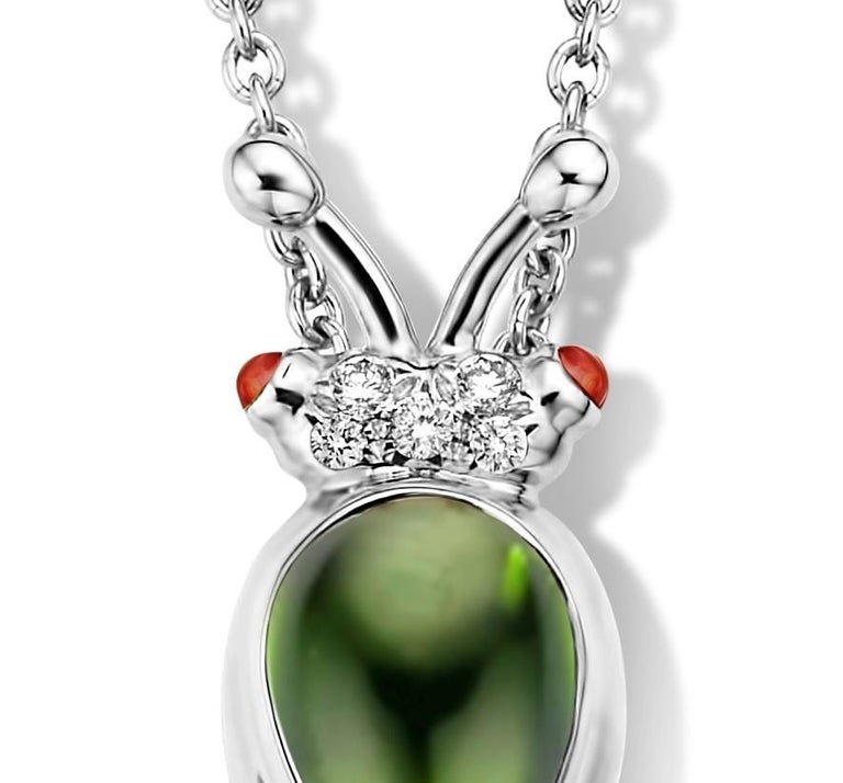 One of a kind lucky beetle necklace in 18K white gold 6g created by jewelry designer Celine Roelens. This necklace is set with the finest diamonds in brilliant cut 0,04Ct (VVS/DEF quality) and one natural, green tourmaline in pear cabouchon cut