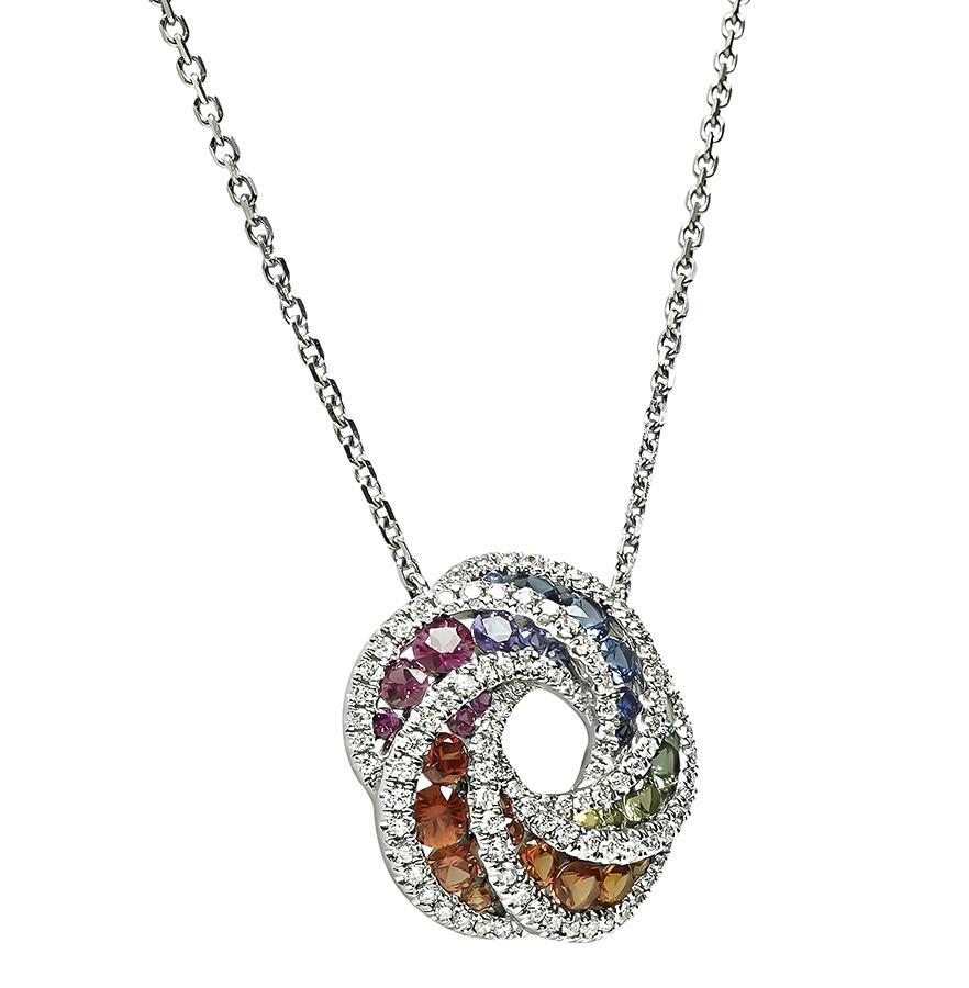 This is an amazing 18k white gold pendant necklace. The pendant is set with lovely round cut multi color sapphires that weigh approximately 1.50ct. The sapphires are accentuated by sparkling round cut diamonds that weigh approximately 1.00ct. The