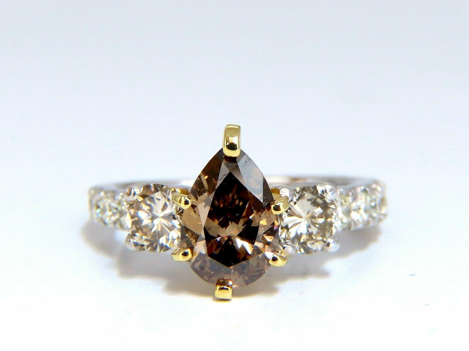 Classic Three & Accent.

1.30ct. Natural Pear diamond ring

Fancy brown color

 Si-1 clarity 

7.6 x 6.2mm

Very good Cut / Full cut Brilliant

Side round white diamonds:

1.00ct Fancy Light Brown color & Si-1 clarity (.50ct each).

Additional .50ct