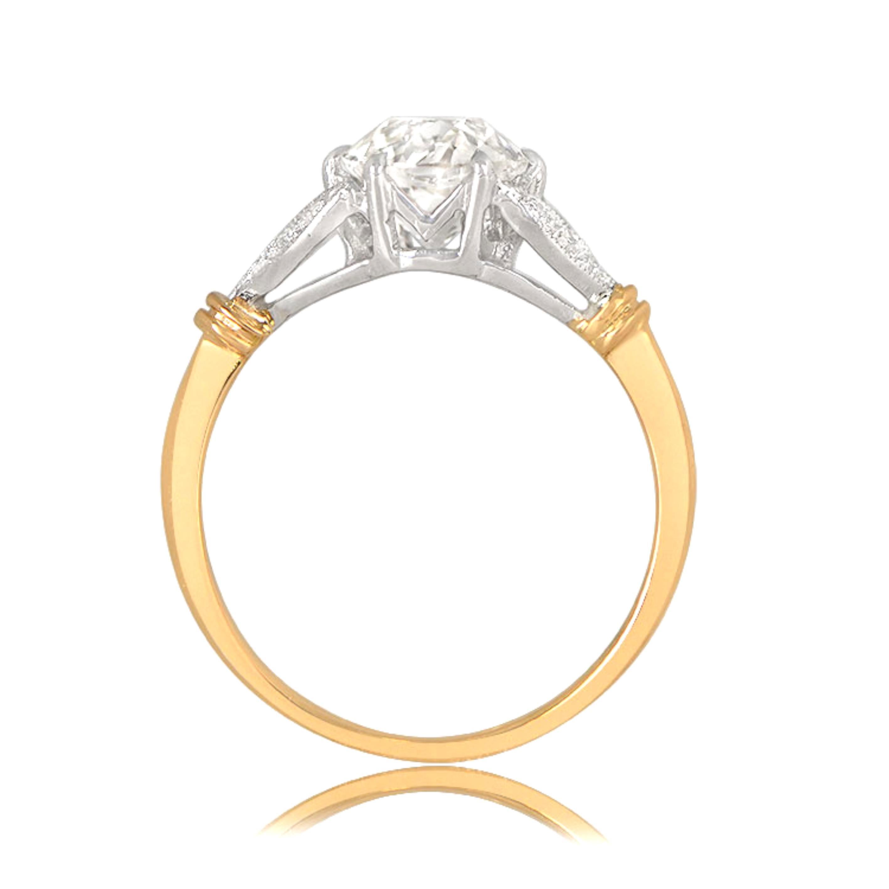 This Edwardian-inspired engagement ring features a delicate leaf motif and a vibrant 1.50-carat old European cut diamond at its center, with K color and VS2 clarity. The two shoulders of the ring are adorned with two leaves each, set with an