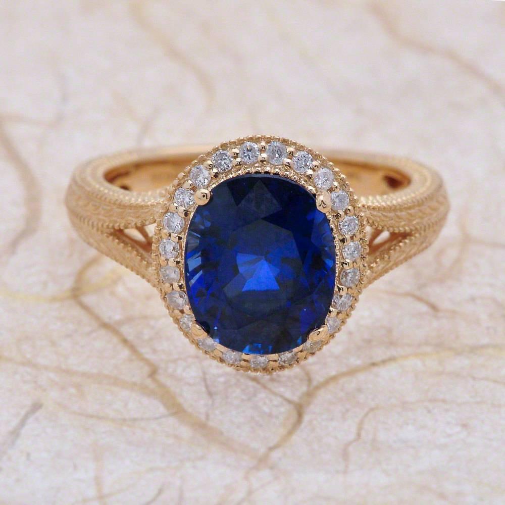 - Center Stone: Oval Cut Blue Sapphire 9x7mm (1.50ct)
- Side Stones: Round Cut Diamonds 0.30ctw / Graded G SI1
- Metal: 14K Yellow Gold

This piece is made-to-order. Please allow up to 7 Business Days to accomplish.