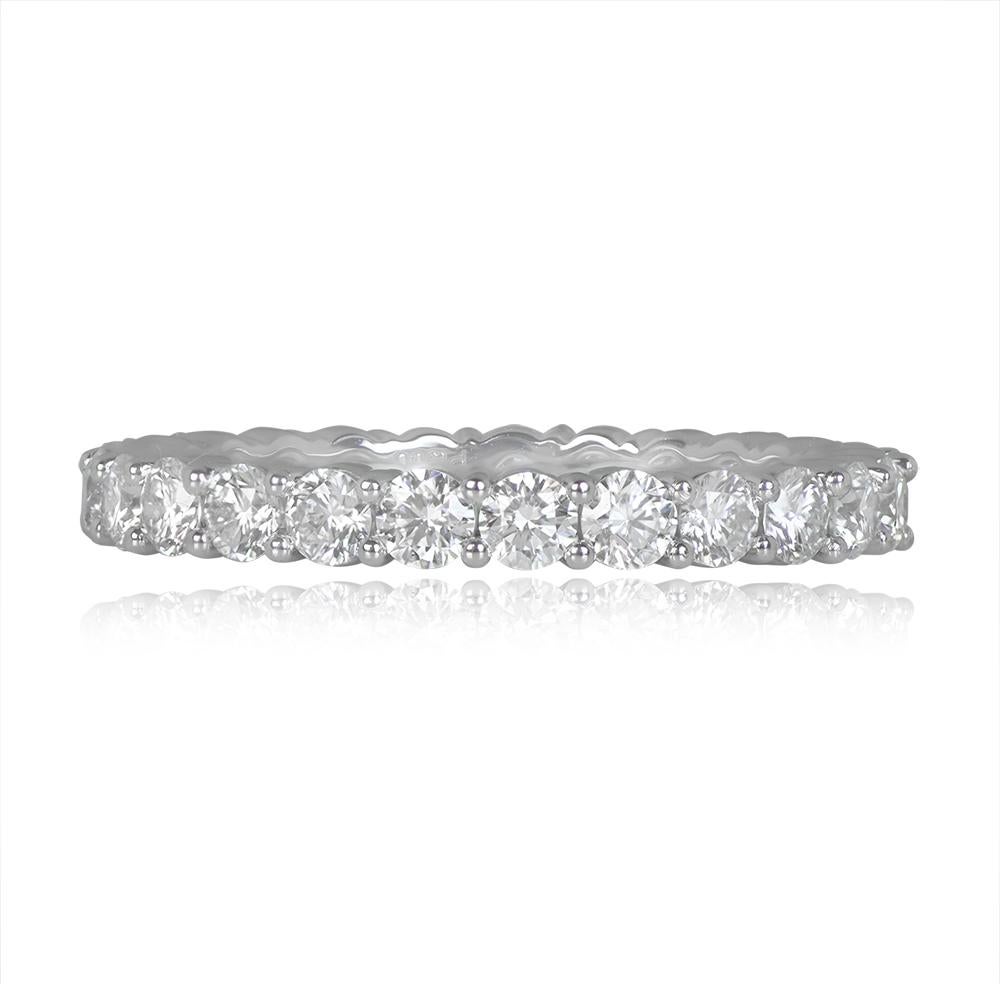 A platinum eternity band adorned with approximately 1.50 carats of lively round brilliant cut diamonds, H color, and VS1-VS2 clarity. The diamonds are set in platinum shared prongs that encircle the band's perimeter. Handmade mounting enhances the
