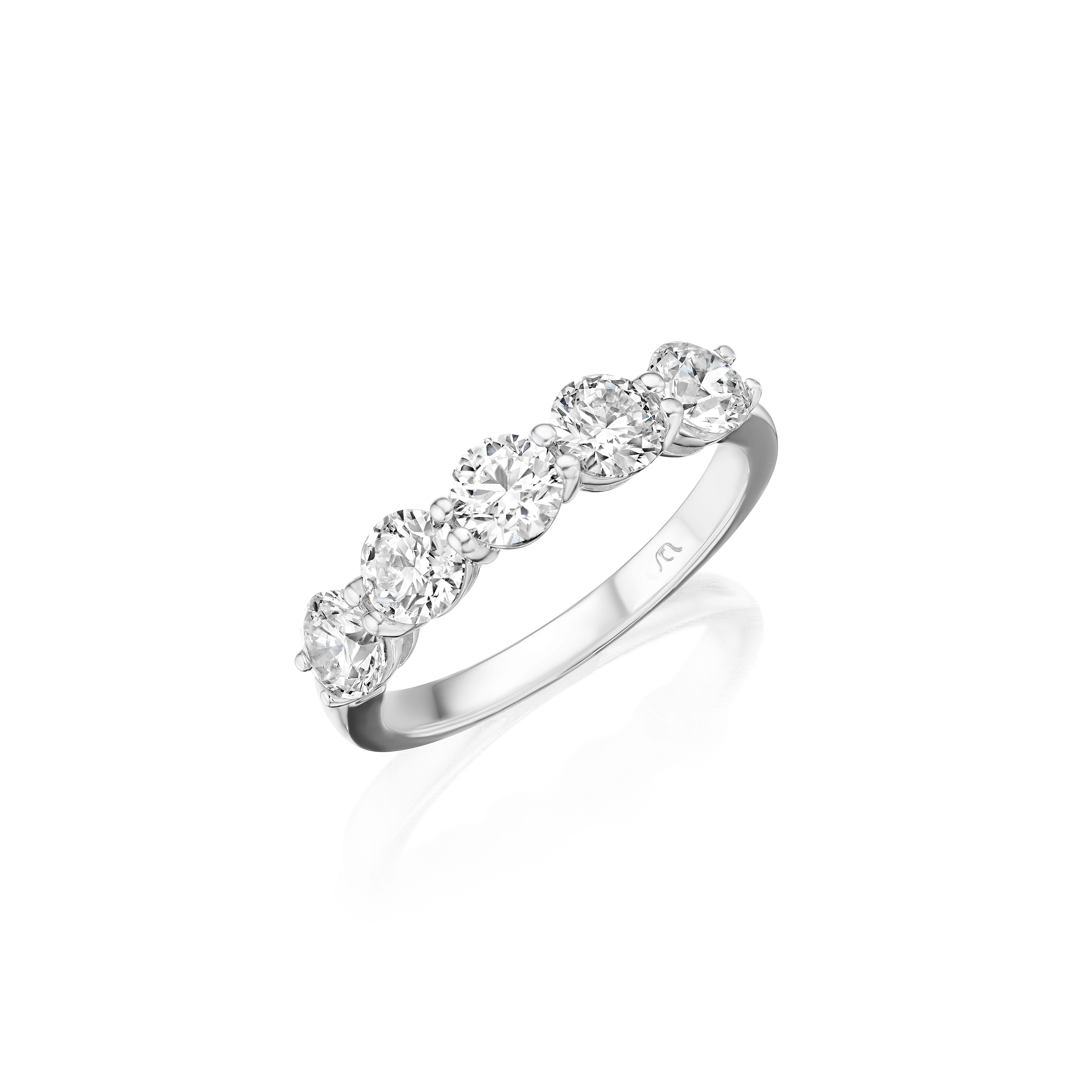 • Crafted in 18KT gold, this band is made with 5 round diamonds, and has a combining total weight of approximately 1.50 carats. The diamonds are set into a shared prong setting. Worn beautifully on its own or stacked. A beautiful and versatile piece