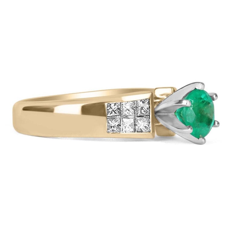 Showcased is a striking genuine, round, Colombian emerald and princess cut diamond ring. Handcrafted in solid 18K yellow gold and platinum, this ring features a breathtaking round Colombian emerald that weighs a perfect 0.90-carat and is set in a