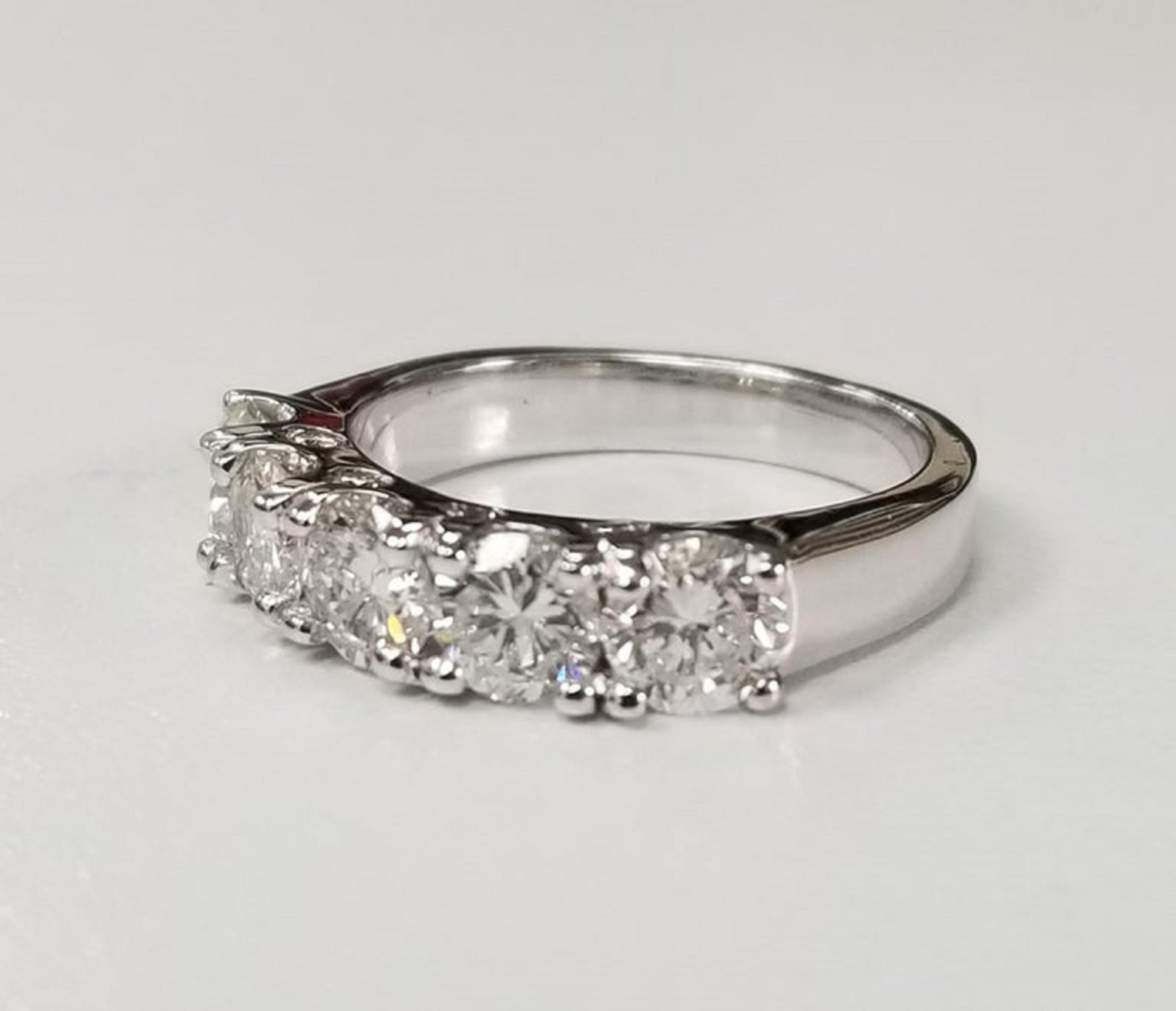 14k white gold diamond wedding ring containing 5 brilliant cut diamonds; color H-I