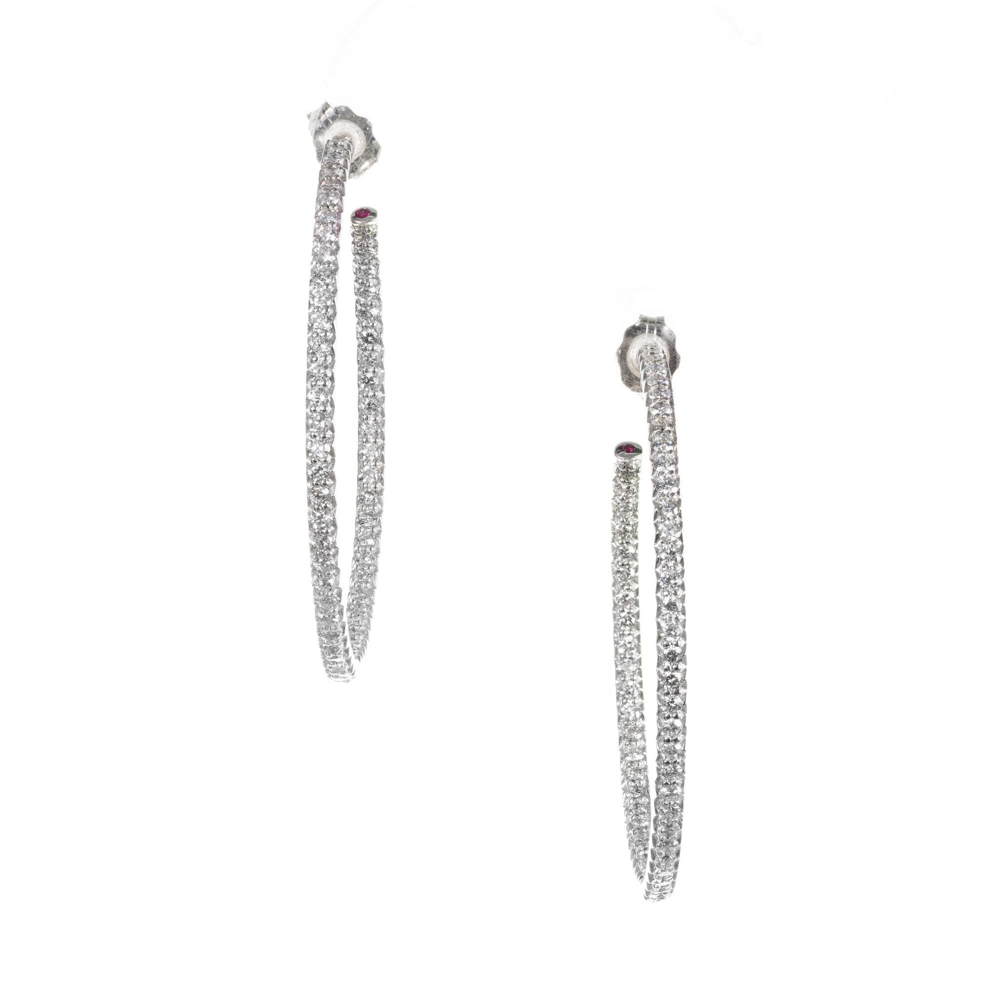 Roberto Coin Diamond Inside Outside hoop style earrings.  one ruby at the end of each hoop. 

112 round brilliant cut H-I VS-SI diamonds, Approximate 1.50ct 
2 round rubies, Approximate .01cts
18k white gold 
Stamped: 18k
6.4 grams
Top to bottom: