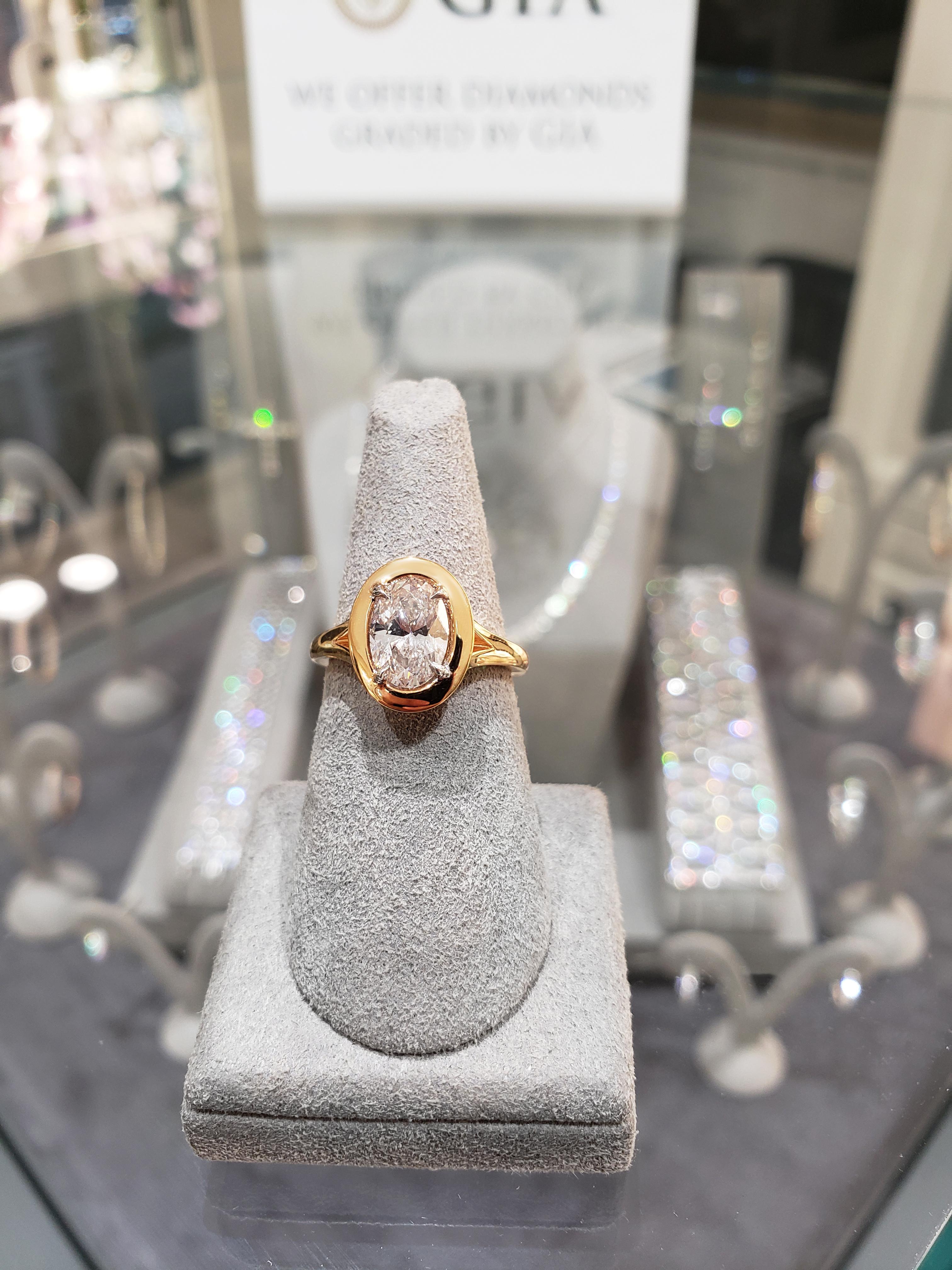 Features a 1.51 carat brown-tinted oval cut diamond center stone set in a polished rose gold bezel. Attached to a chic split-shank band made with 18 carat rose gold.

Style available in different price ranges. Prices are based on your selection of