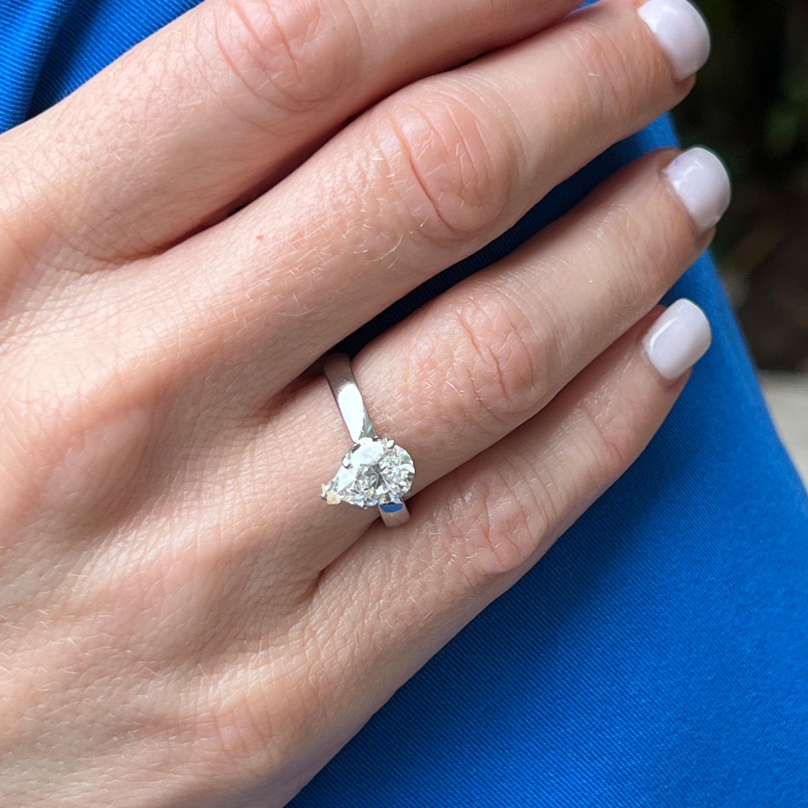 Pear shape diamond engagement ring fashioned in platinum. The solitaire features an 1.51 carat pear shape diamond graded by the GIA G color and VS2 clarity. The ring is currently size 5.75 (can be sized), and the shank measures 3.2mm in width. 