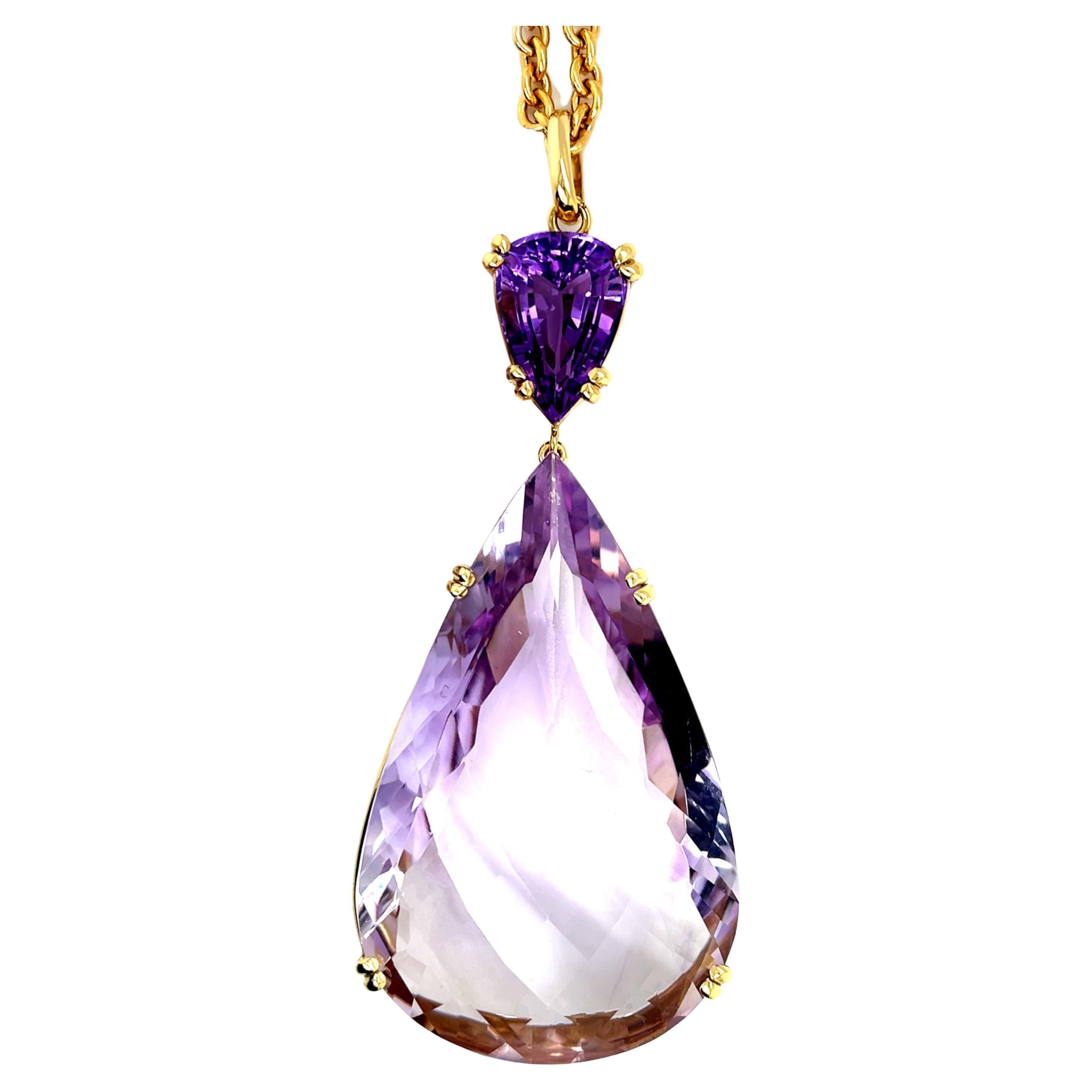 This spectacular pendant showcases a giant gemstone in one of the prettiest shades of amethyst - the soft and delicate, pastel pinkish purple aptly named, 