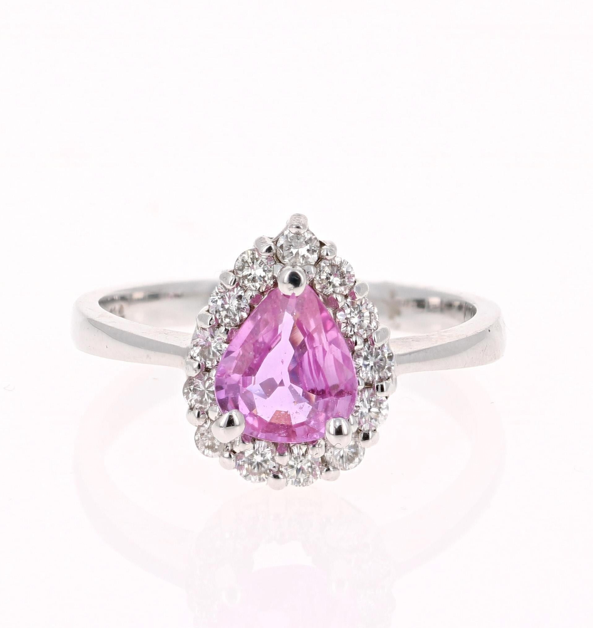 Gorgeous Pink Sapphire Diamond Ring with a classic setting! Can be a very unique Engagement Ring or Cocktail Ring! 

The center Pear Cut Pink Sapphire is 1.12 Carats surrounded by a halo of 13 Round Cut Diamonds weighing 0.39 Carats. The total carat