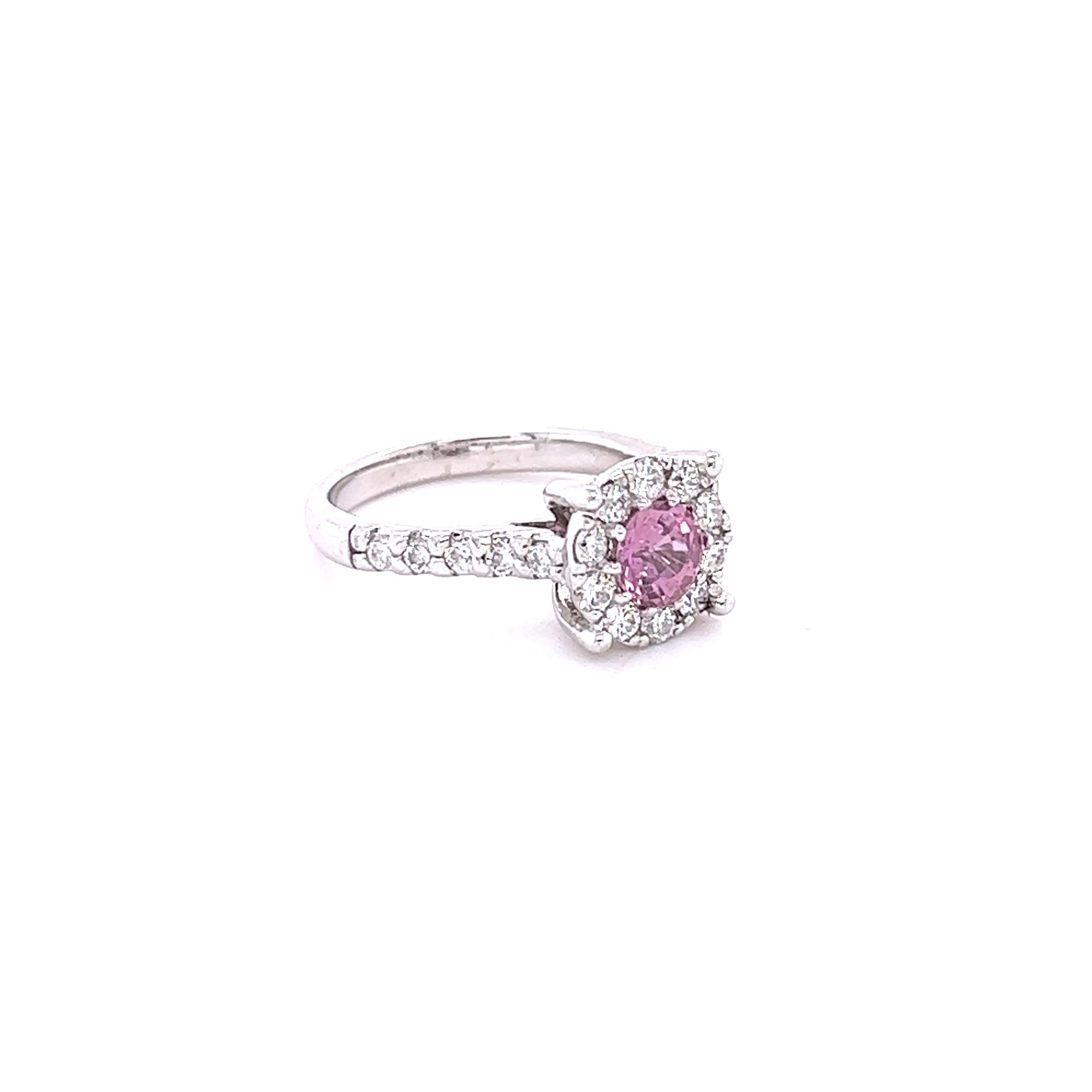 This beautiful ring has a Natural Round Cut Pink Sapphire that weighs 0.84 Carats and measures at approximately 5 mm. 

The ring is embellished with 20 Round Cut Diamonds that weigh 0.67 Carats with a clarity and color of SI-F.
The total carat