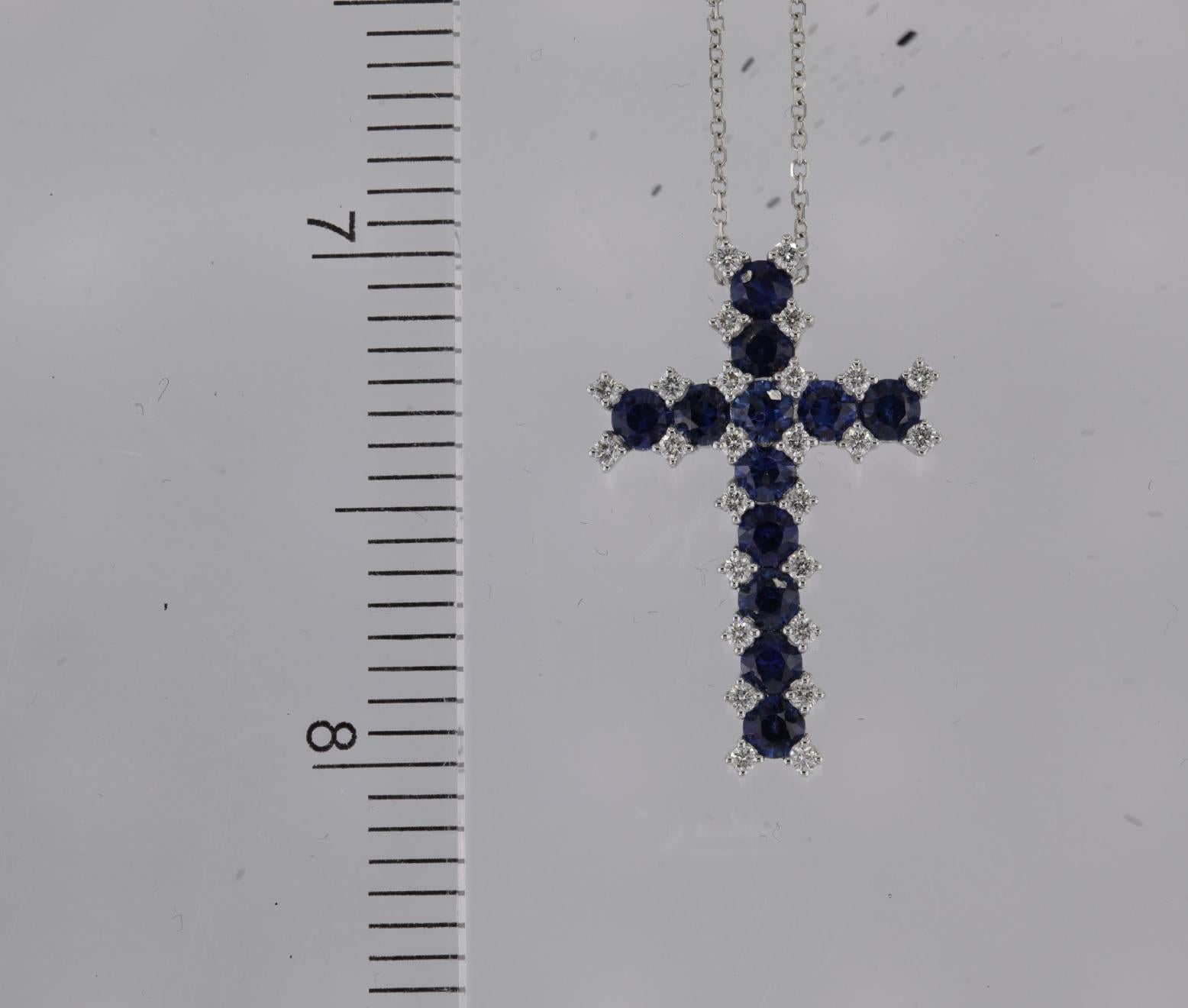 Explore the elegance of this sapphire cross pendant, adorned with 1.51 carats of brilliant blue round sapphires and 0.26carats of natural round diamonds. This pendant serves as a genuine symbol of grace and is an excellent gift choice.

Total