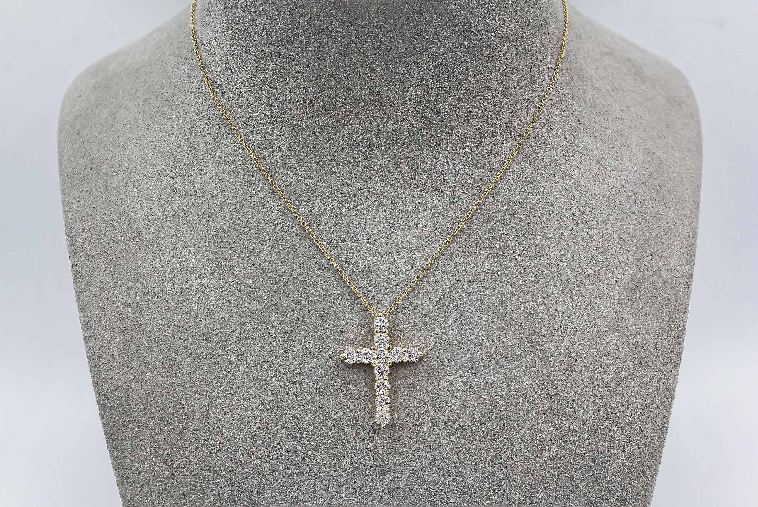 Showcasing round brilliant diamonds set in a religious cross made in 14 karat yellow gold. Diamonds weigh 1.51 carats total. Suspended on an 18 inch yellow gold chain. 

Style available in different price ranges. Prices are based on your selection