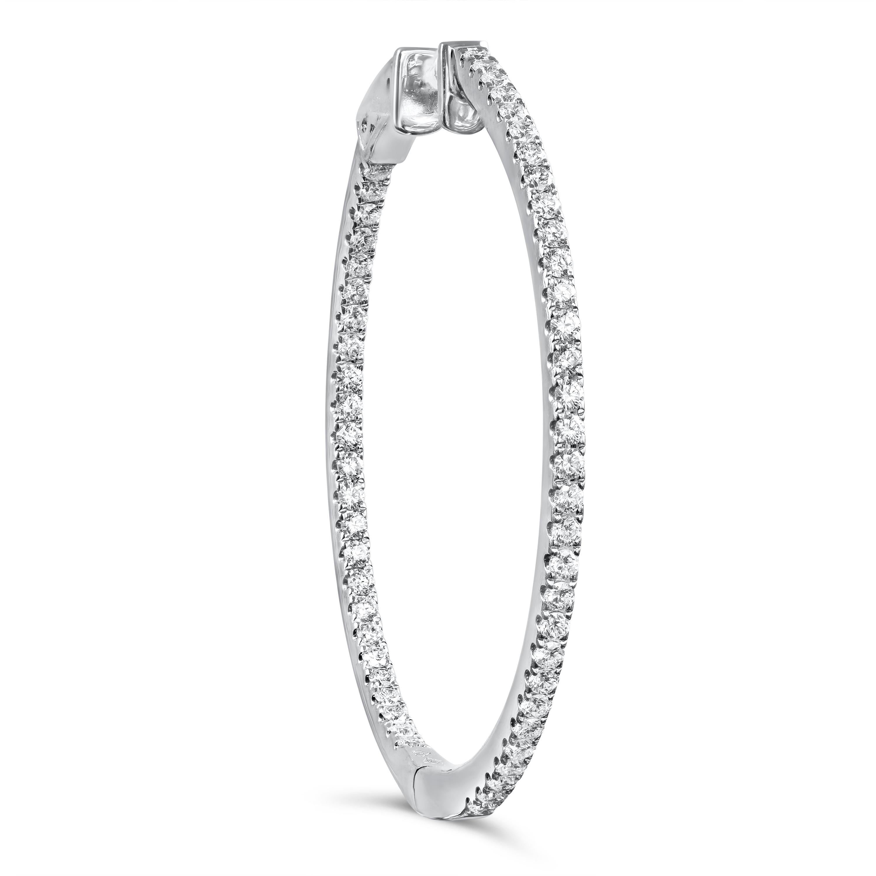 A simple yet lustrous pair of hoop earrings showcasing 1.51 carats of round brilliant diamonds scalloped pave set on an 18 karat white gold. Approximately 1.75 inches in length. 

Roman Malakov is a custom house, specializing in creating anything