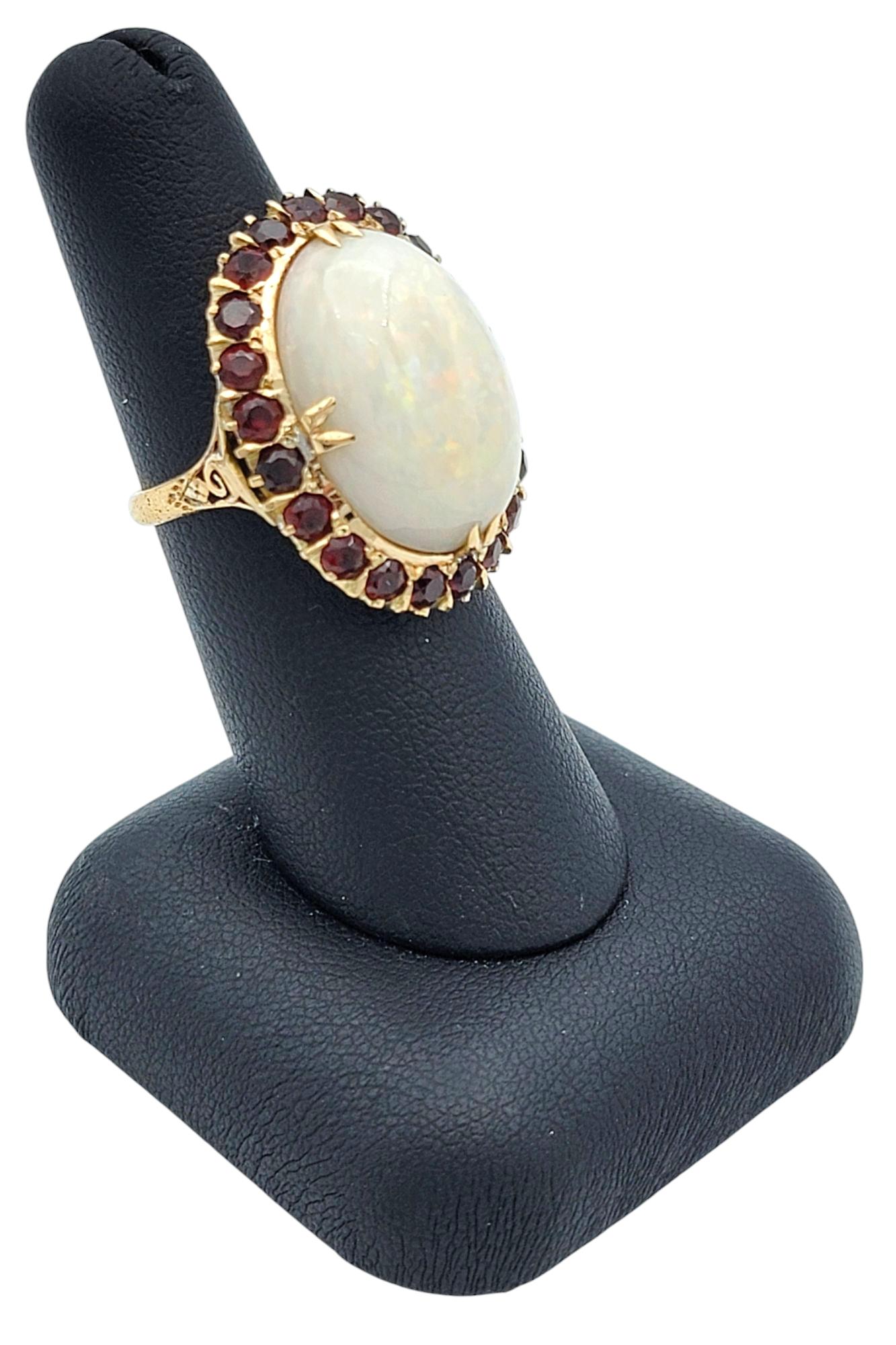 15.12 Carat Oval Cabochon Opal Cocktail Ring with Garnet Halo in 14 Karat Gold For Sale 4