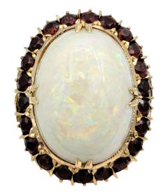 15.12 Carat Oval Cabochon Opal Cocktail Ring with Garnet Halo in 14 Karat Gold