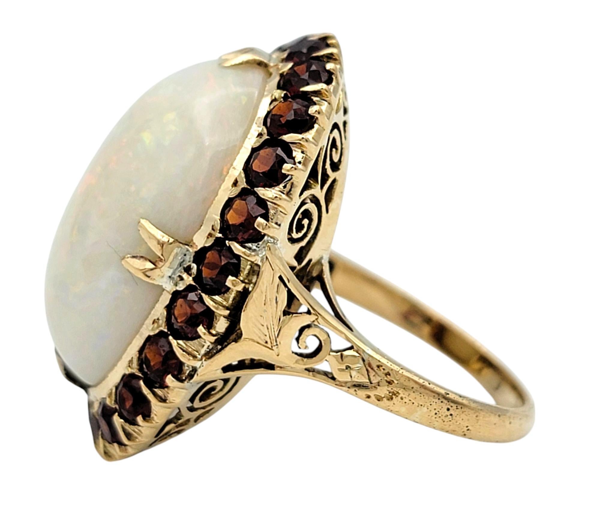 15.12 Carat Oval Cabochon Opal Cocktail Ring with Garnet Halo in 14 Karat Gold In Good Condition For Sale In Scottsdale, AZ