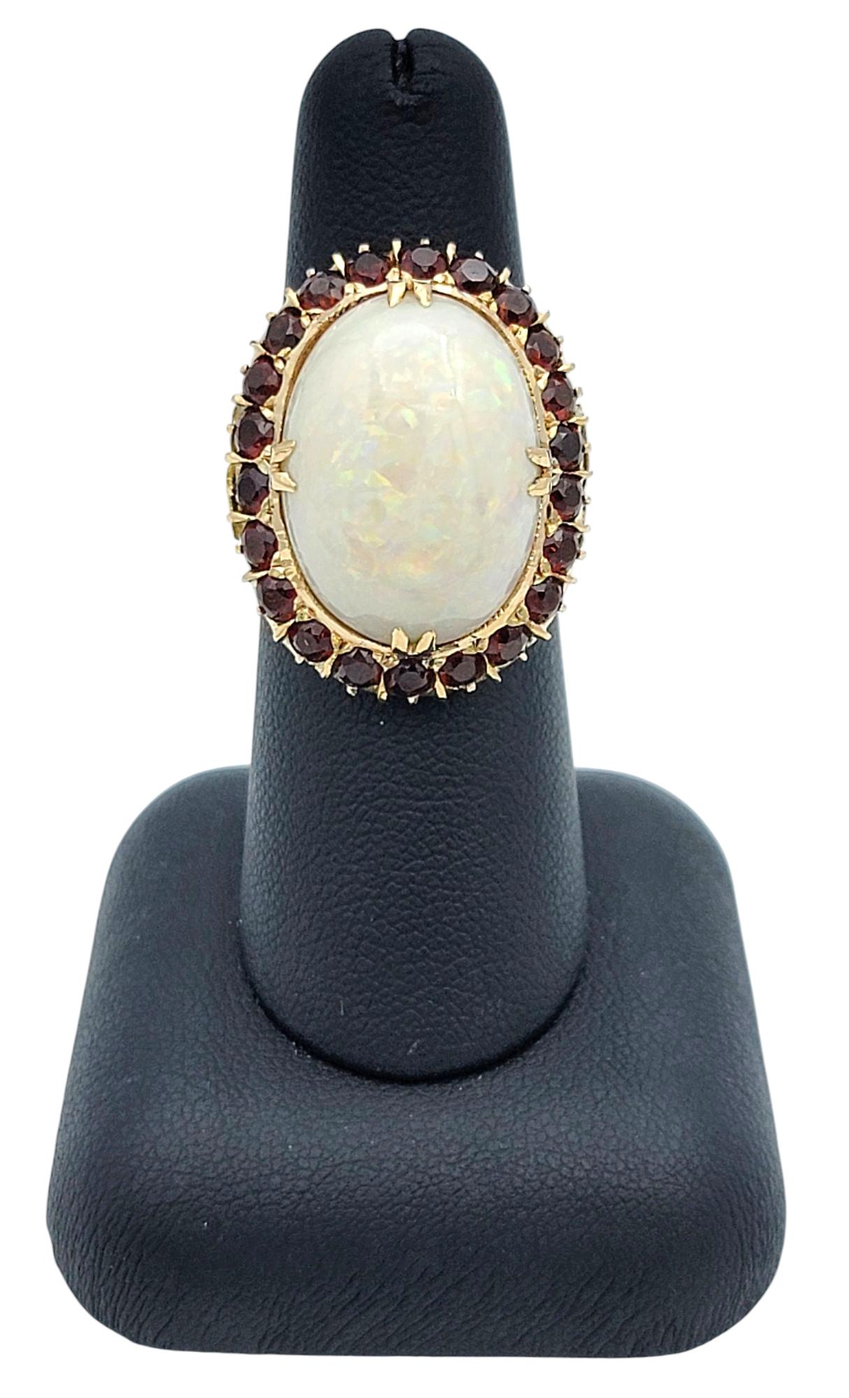 15.12 Carat Oval Cabochon Opal Cocktail Ring with Garnet Halo in 14 Karat Gold For Sale 3