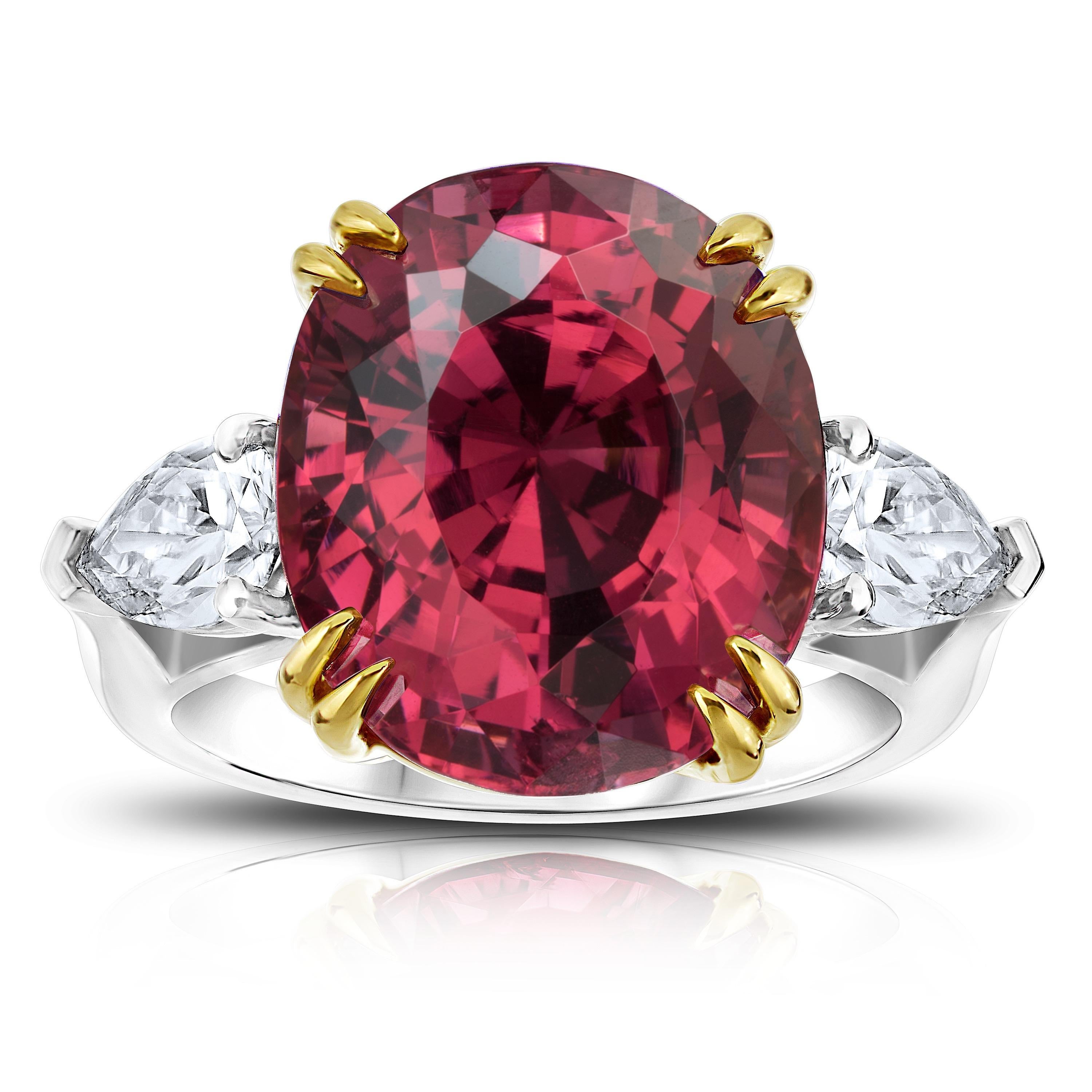 15.13 carat Red Spinel three stone ring with pear shape diamonds weighing 1.03 carats set in a custom platinum ring with 18k yellow gold basket.

