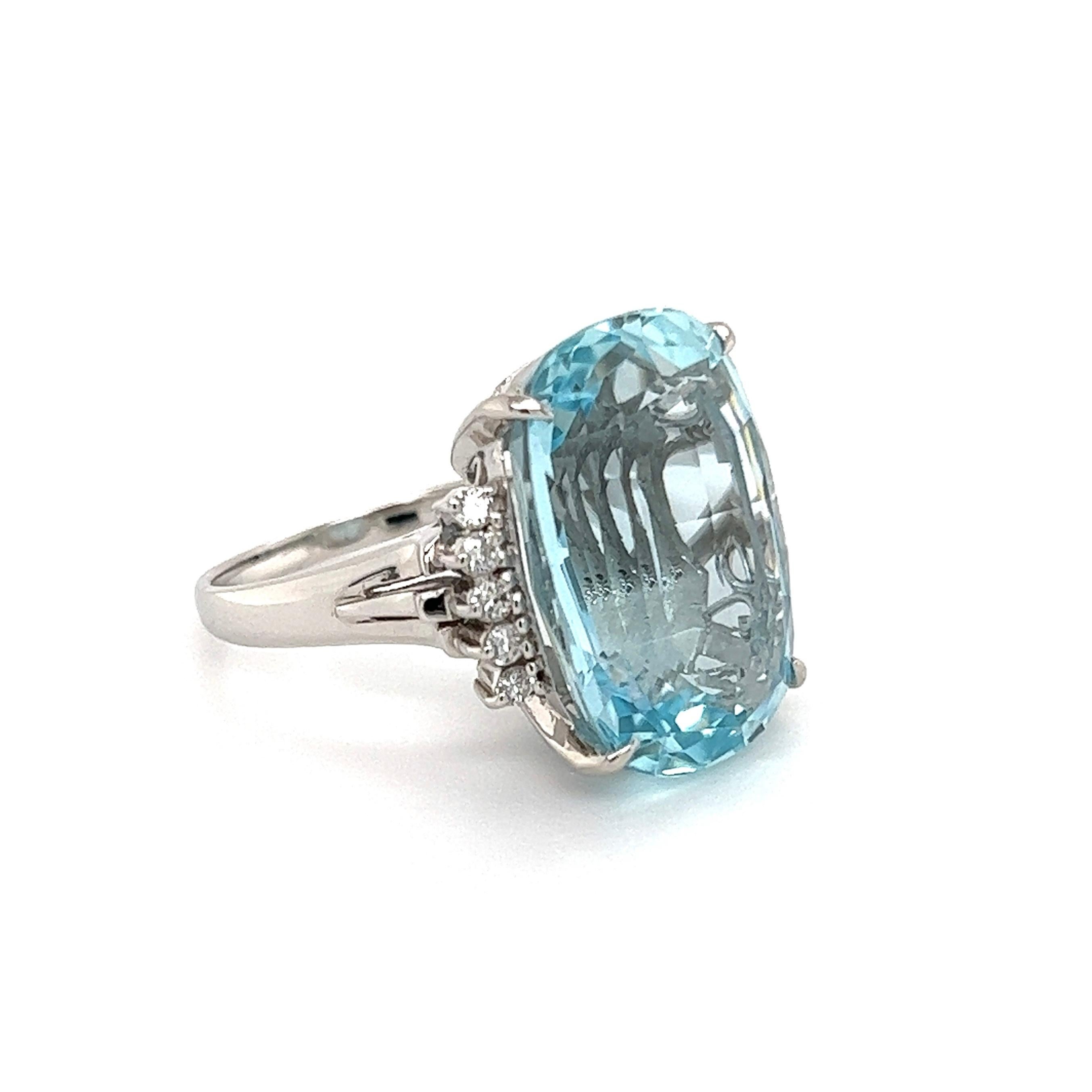 Simply Beautiful! Elegant and finely detailed Platinum Diamond Cocktail Ring. Center securely nestled Hand set with an Elongated Aquamarine, weighing approx. 15. 16 Carat and Diamonds on either side, weighing approx. 0.20tcw. Ring measuring approx.