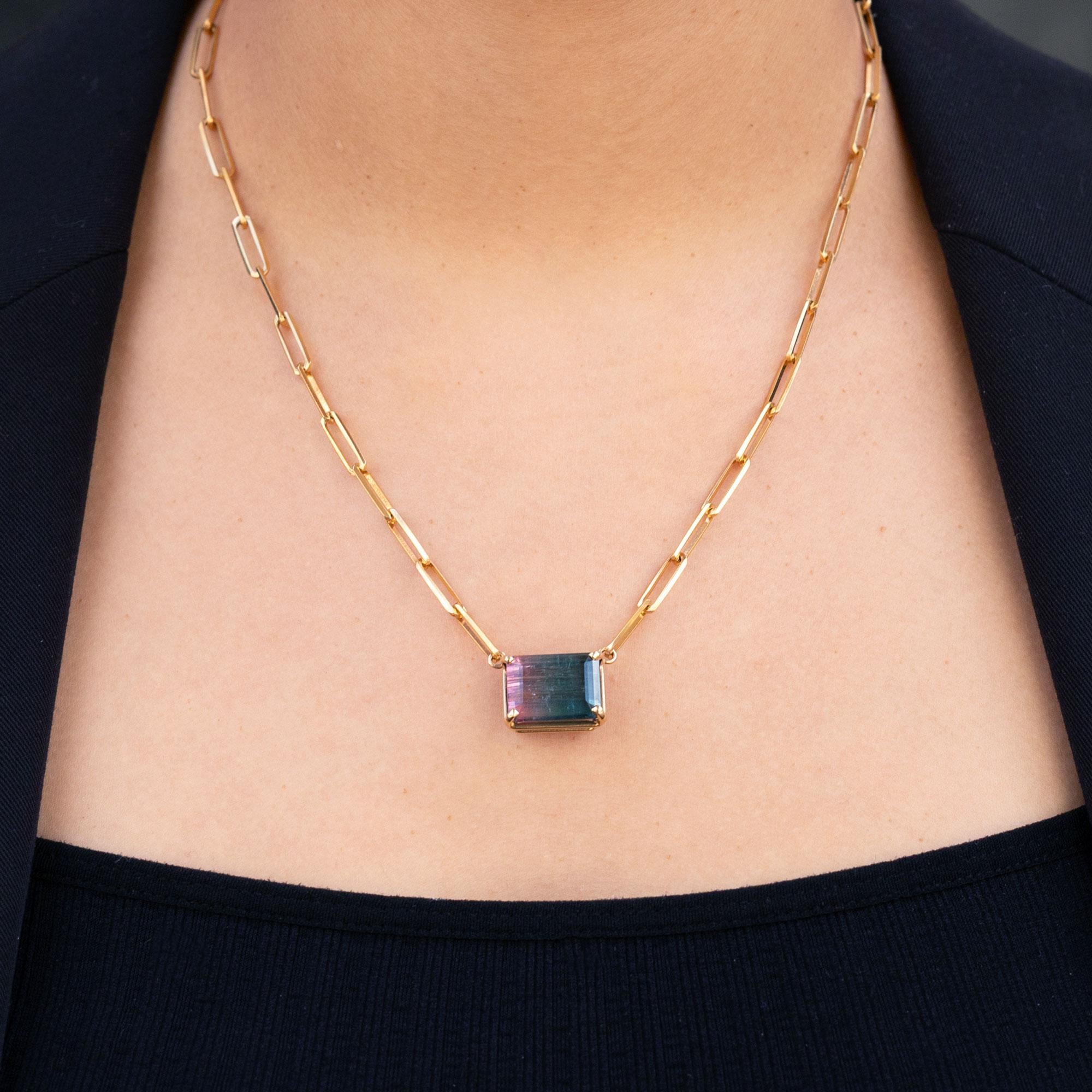 This lovely vintage pendant centers on a spectacular watermelon tourmaline, a highly sought after by gemstone collectors and jewelry lovers alike. Weighing over 15 carats, it displays green and pink tones caused by traces of iron, titanium and