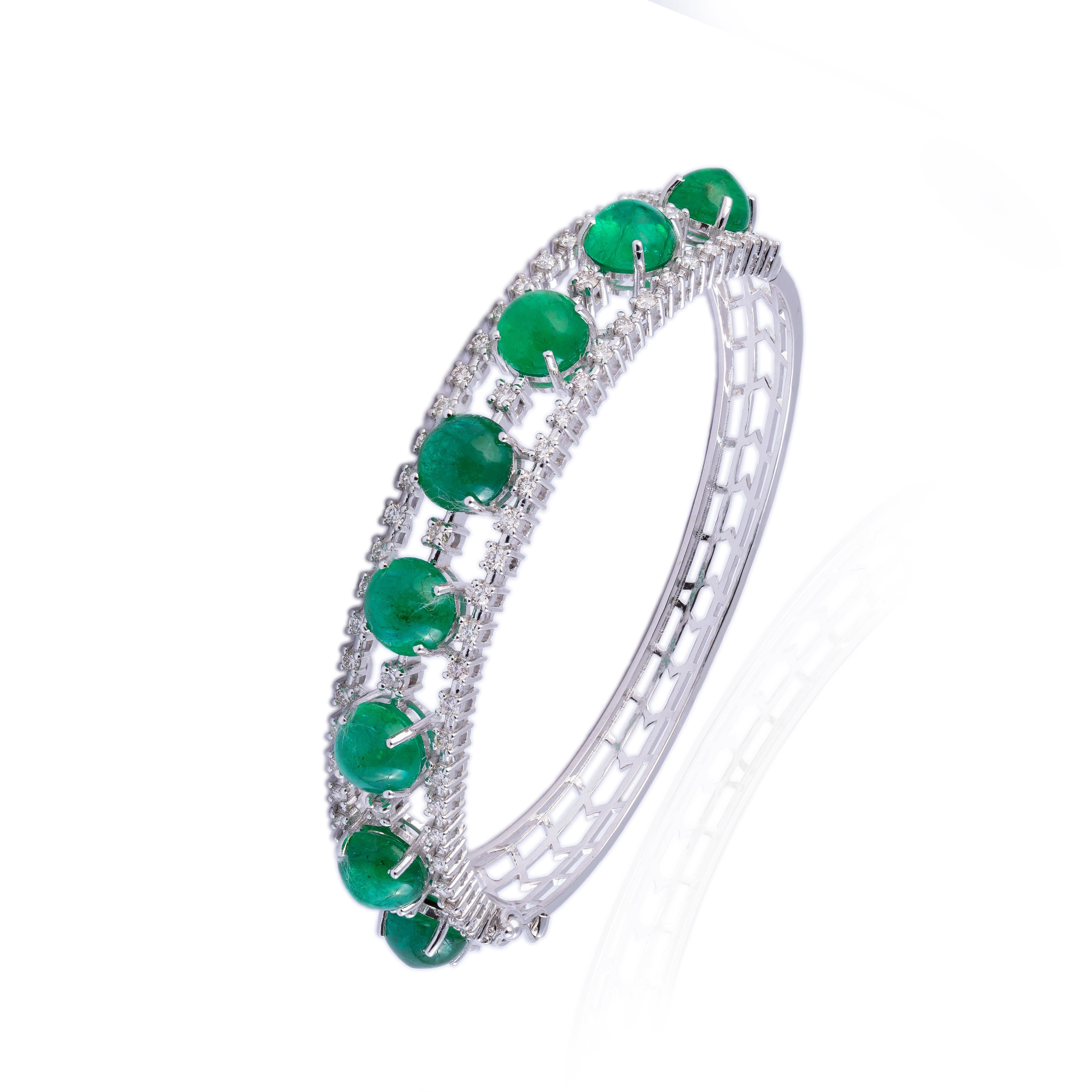 this is a very elegant natural emerald and diamond bracelet in 14k gold. the e.eralds are caboshans of very high quality.

emeralds : 15.18 cts
diamonds : 1.59 cts
gold : 17.49 gms

Its very hard to capture the true color and luster of the stone, I