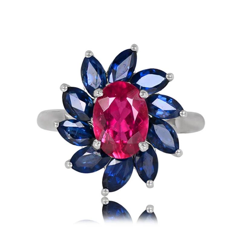 This ring features a 1.51-carat rubellite set in prongs, surrounded by a cluster of sapphires prong-set in a floral design. The total carat weight of the sapphires is 2.98 carats. This ring is 18k white gold.

Ring Size: 6.5 US, Resizable
Metal: