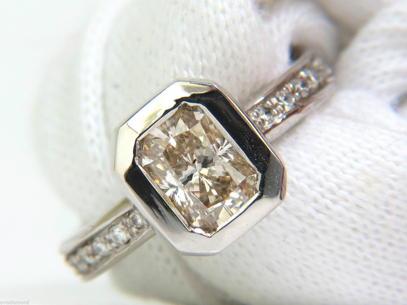 Modern Deco

1.12ct. Radiant diamond 

Si-2 clarity



.40ct. side diamonds

G-color, Si-1 clarity



4.4 grams



Deck of ring 

9.7 X 8.6mm



Depth: 4.9mm



size: 5.25

(no resizing possible)

14kt. white gold. 

$8000 appraisal will accompany