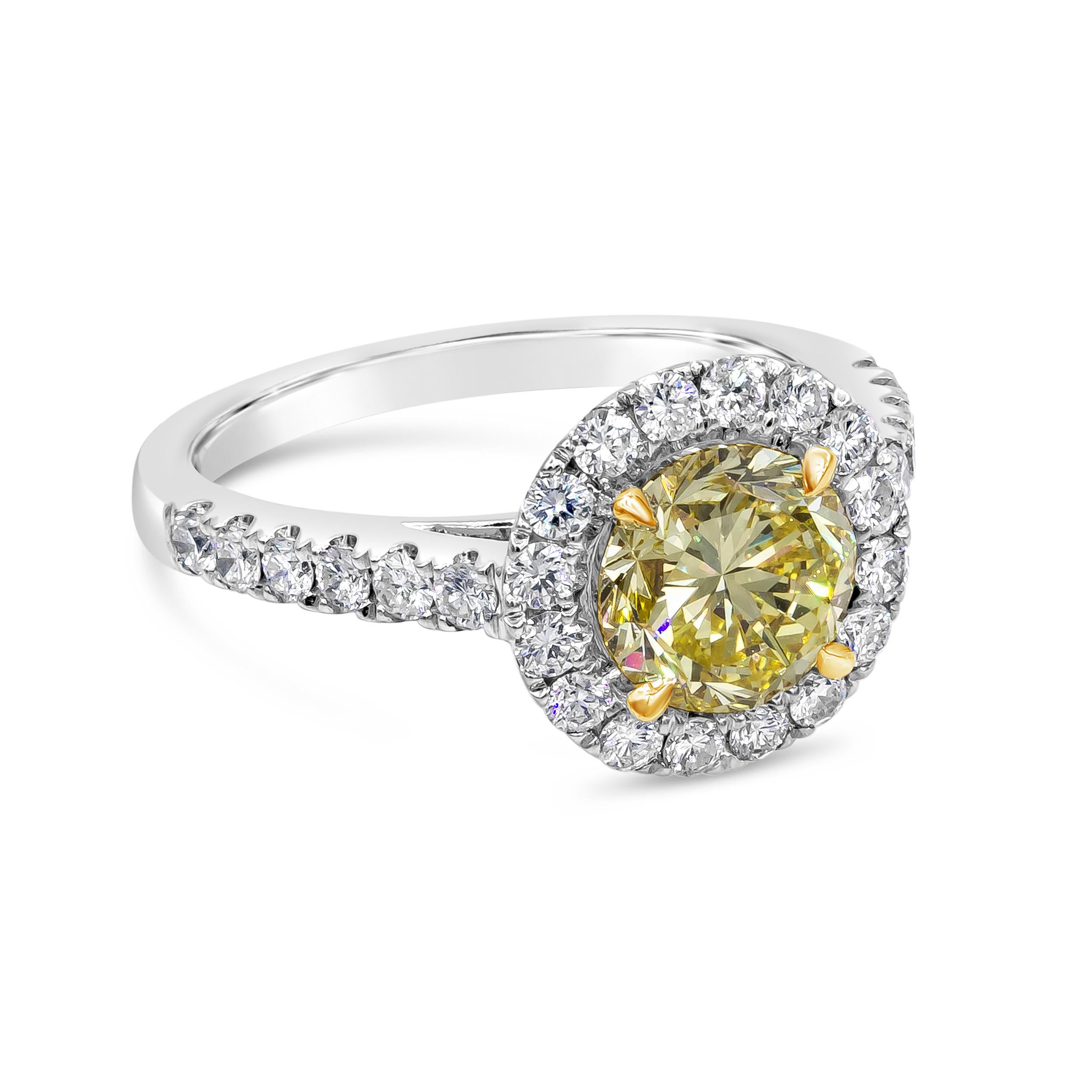 A color-rich engagement ring showcasing a 1.51 carats brilliant round cut diamond certified by GIA as Fancy Intense Yellow color and SI2 in clarity. Surrounded by a single row of round brilliant diamonds in halo pave half eternity setting. Accent