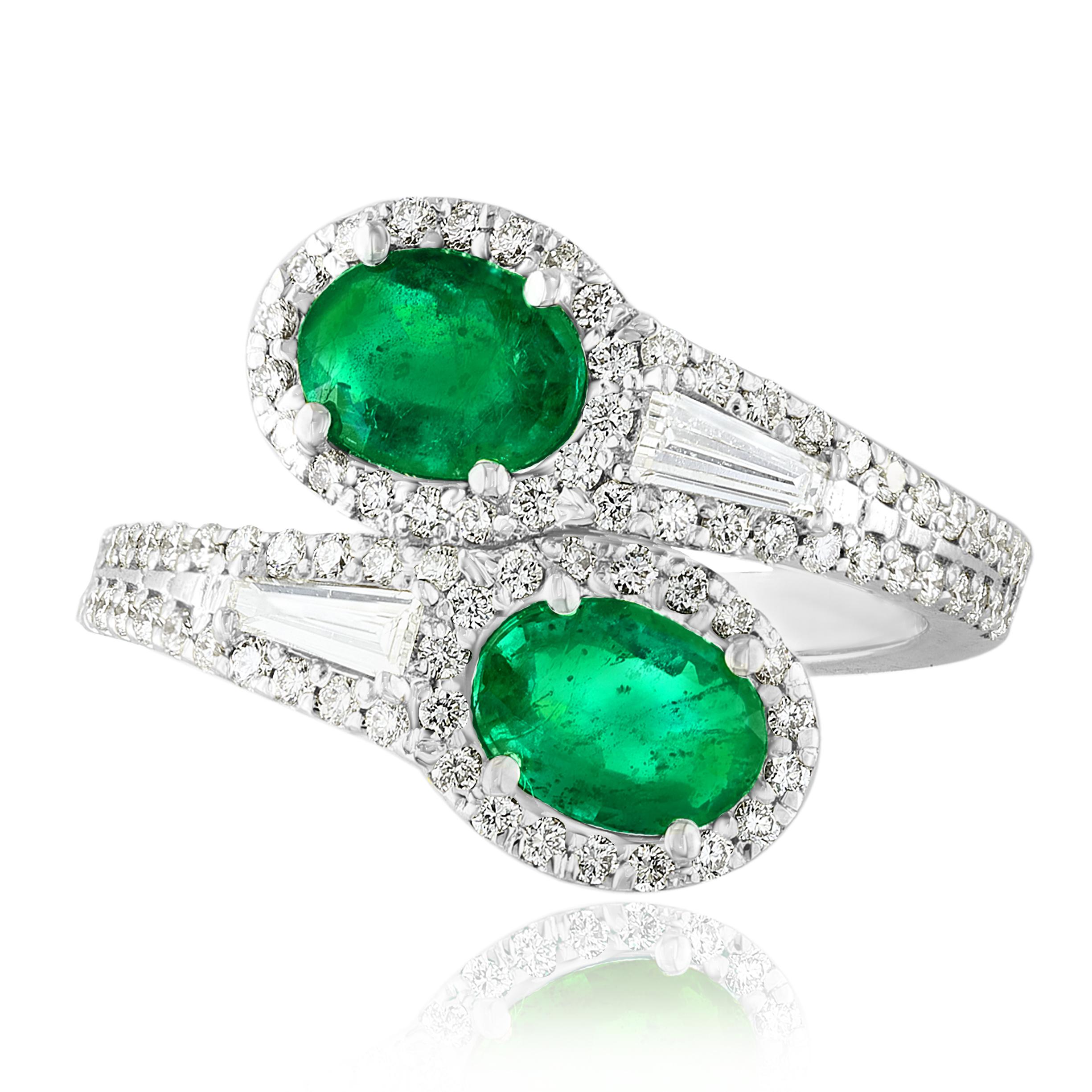 The stunning forever-together Toi et Moi ring features 2 Oval cut Emeralds embraced by east to west 2 baguette diamonds weigh and 84 round diamonds halfway to the shank. Handcrafted in 14k White Gold.
2 oval Emeralds in the center weigh 1.52 carats
