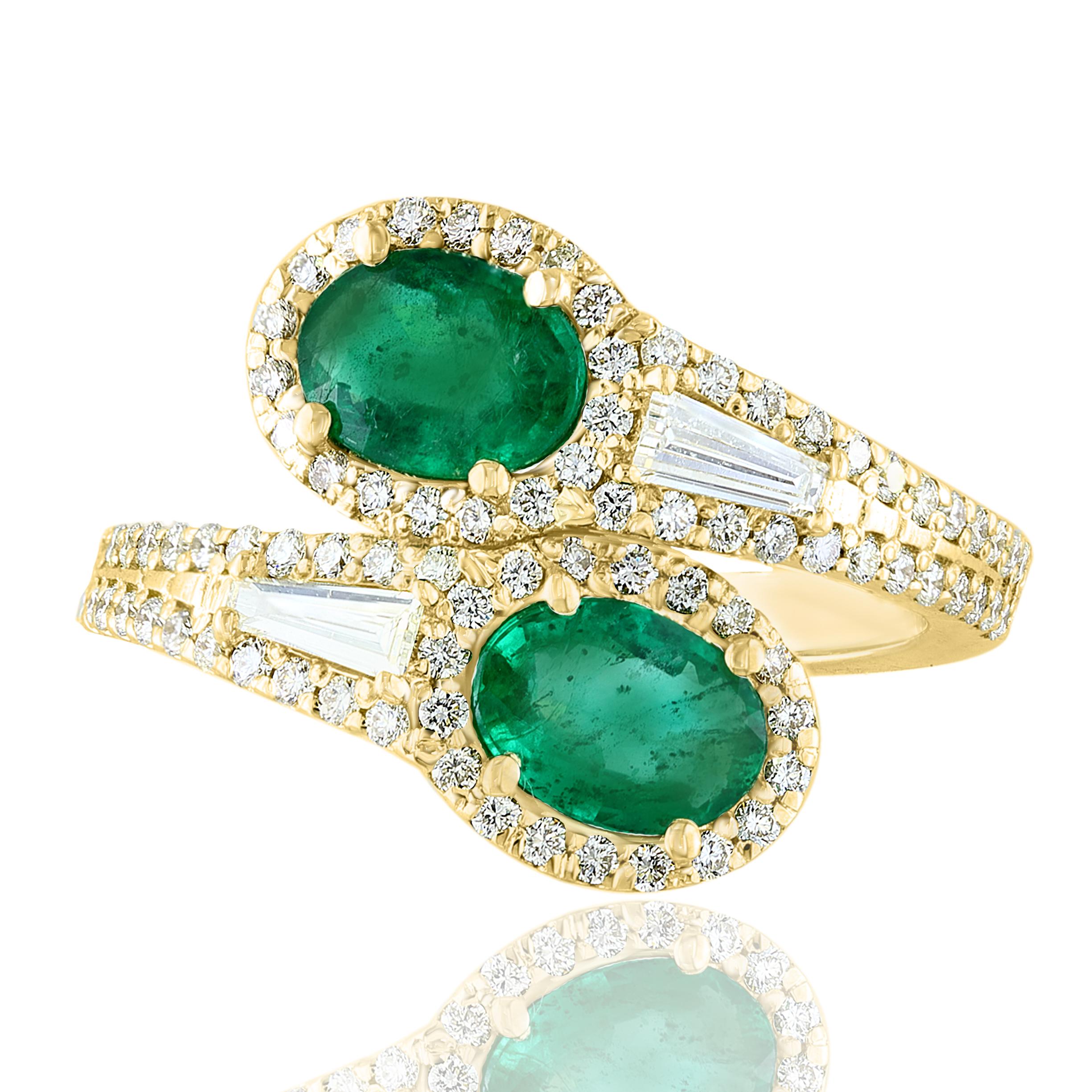 The stunning forever-together Toi et Moi ring features 2 Oval cut Emeralds embraced by east to west 2 baguette diamonds weigh and 84 round diamonds halfway to the shank. Handcrafted in 14k Yellow Gold.
2 oval Emeralds in the center weigh 1.52 carats
