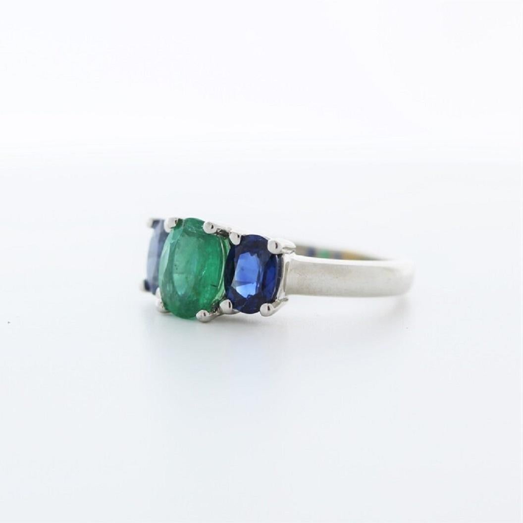 A fashion ring featuring a 14k white gold band with a main stone of a 1.52 carat oval-cut emerald, accompanied by two oval-cut sapphires totaling 1.9 carats as side stones, would be a stunning and colorful choice.