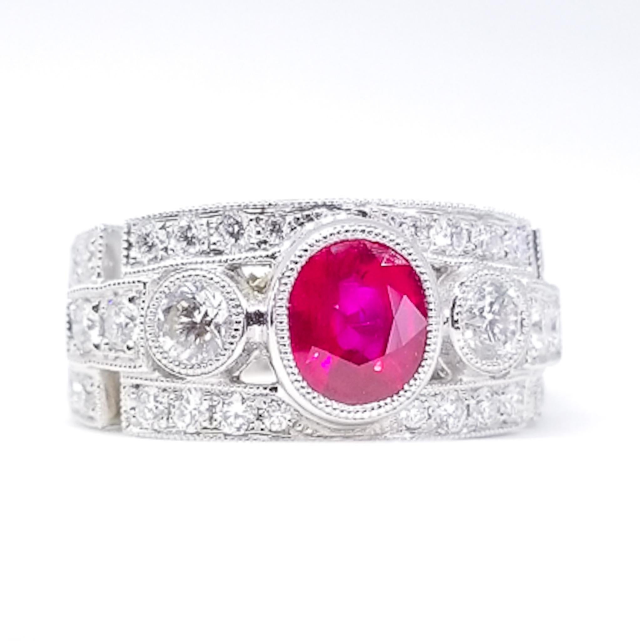 An Art Deco Inspired Engagement, Anniversary or Right Hand Ring is set with a 1.52 Carat Oval Ruby with Rich Red Pink Color Saturation. The Gem Quality stone is set low in the Band Style Ring in a protective bezel of Hand Millegrained White Gold.