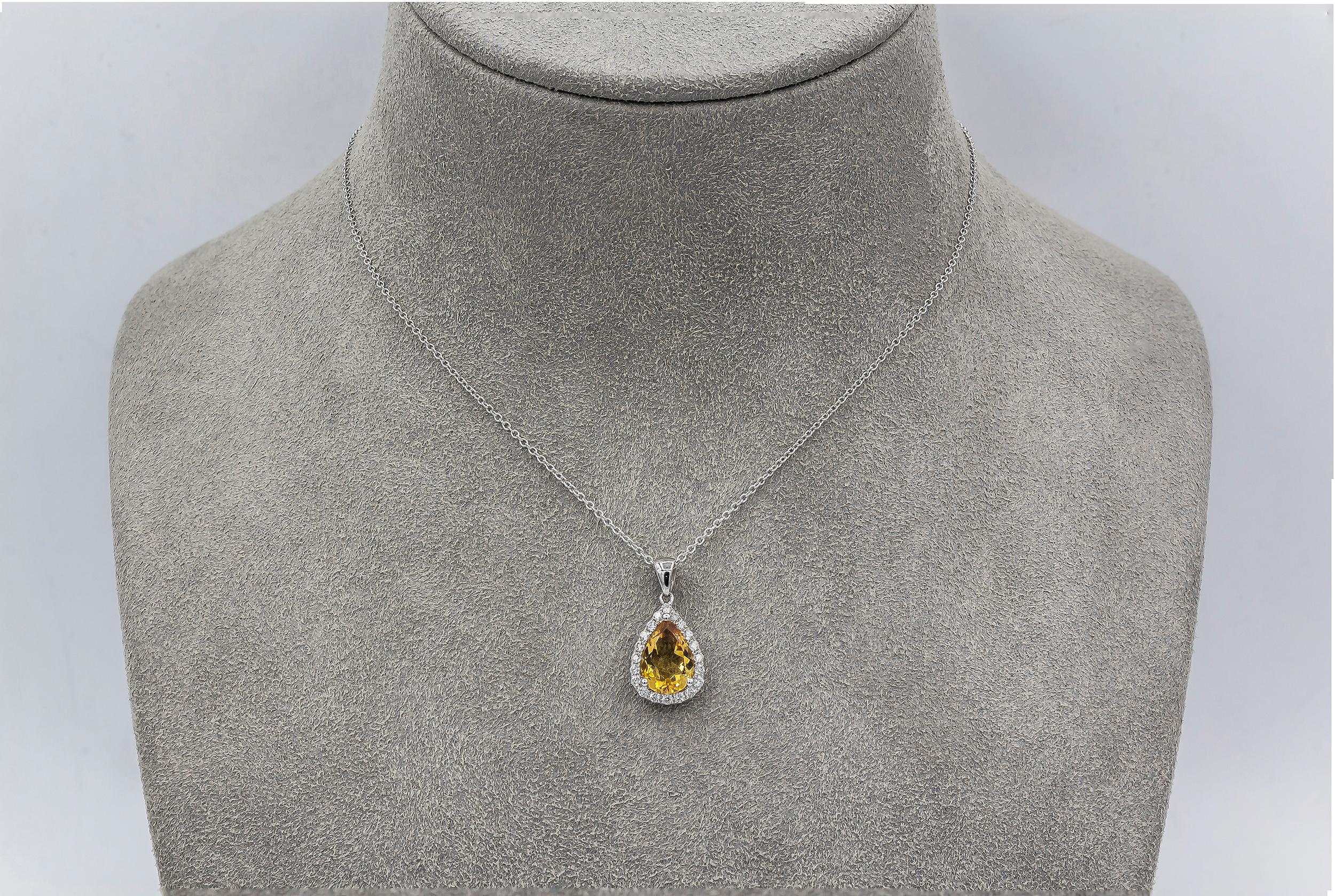 Showcasing a 1.52 carat yellow pear shape citrine, surrounded by a single row of round brilliant diamonds weighing 0.25 carats total. Made in 14 karat white gold. Suspended on a 16 inch white gold chain.

