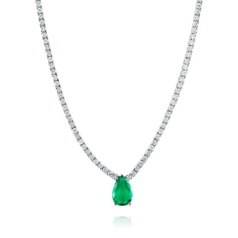 Dazzling 1.52 carat pear-shaped green emerald set with 4.64 carat white diamonds in white gold.

