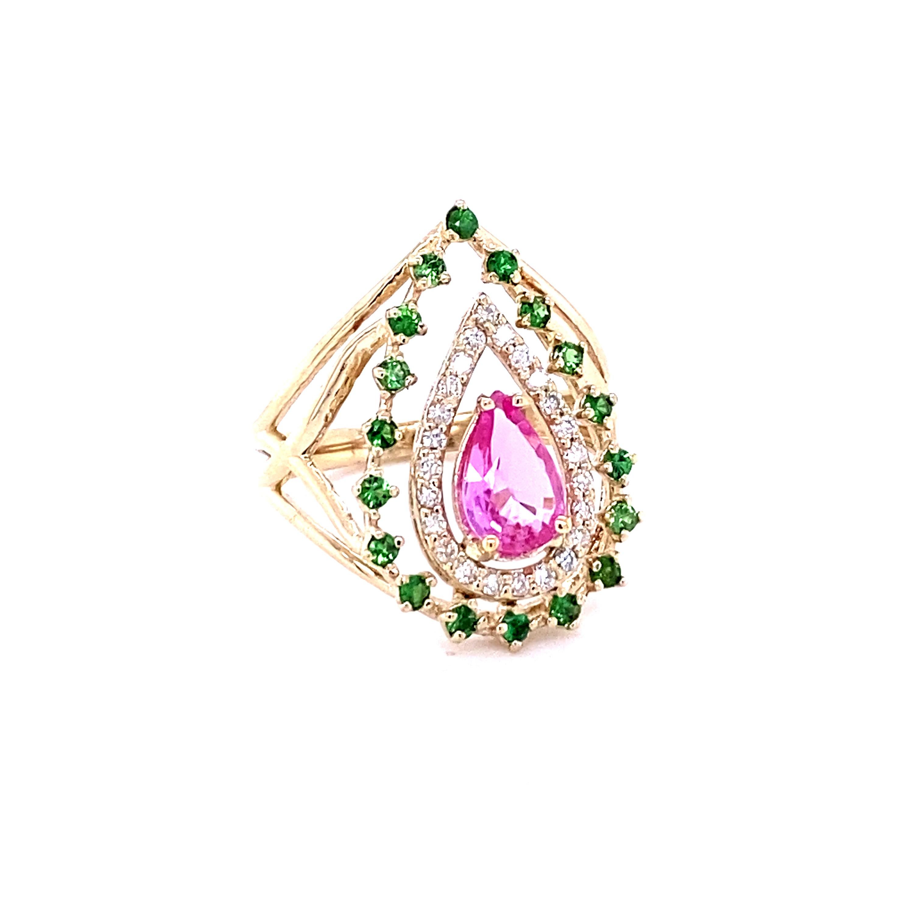 This beautiful ring has a Pear Cut Pink Sapphire that weighs 0.93 Carats.
The ring is embellished with 24 Round Cut Diamonds that weigh 0.23 Carats (Clarity: VS, Color: H) as well as 19 Tsavorites that weigh 0.36 Carats.  The total carat weight of