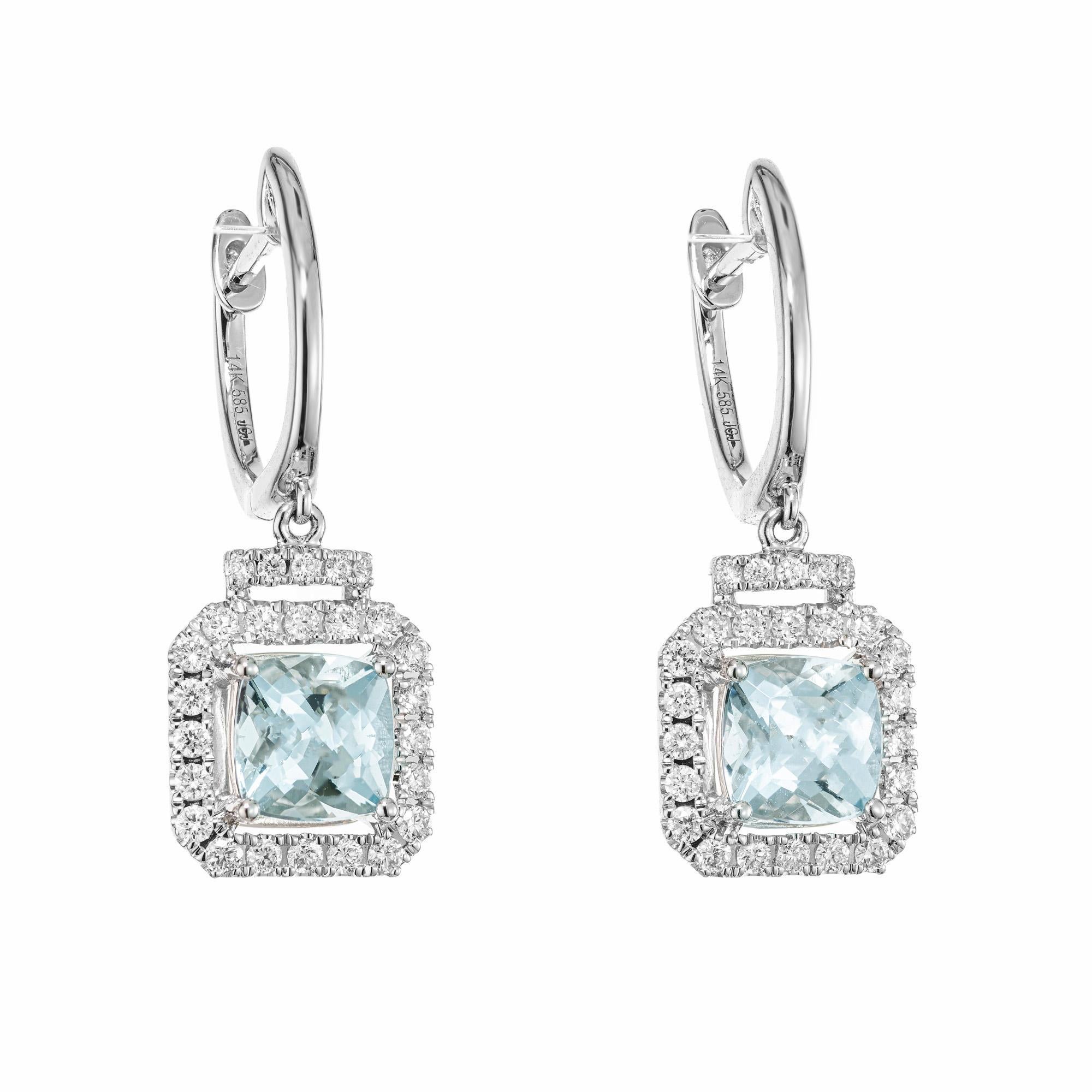 Radiant and elegant Aquamarine Diamond halo dangle earrings. 2 square shaped blue aqua gemstones with a total carat weight of 1.52cts. Each aqua has a halo of round brilliant cut diamonds. Crafted in 14k white gold. 

2 square blue aqua, approx. 
