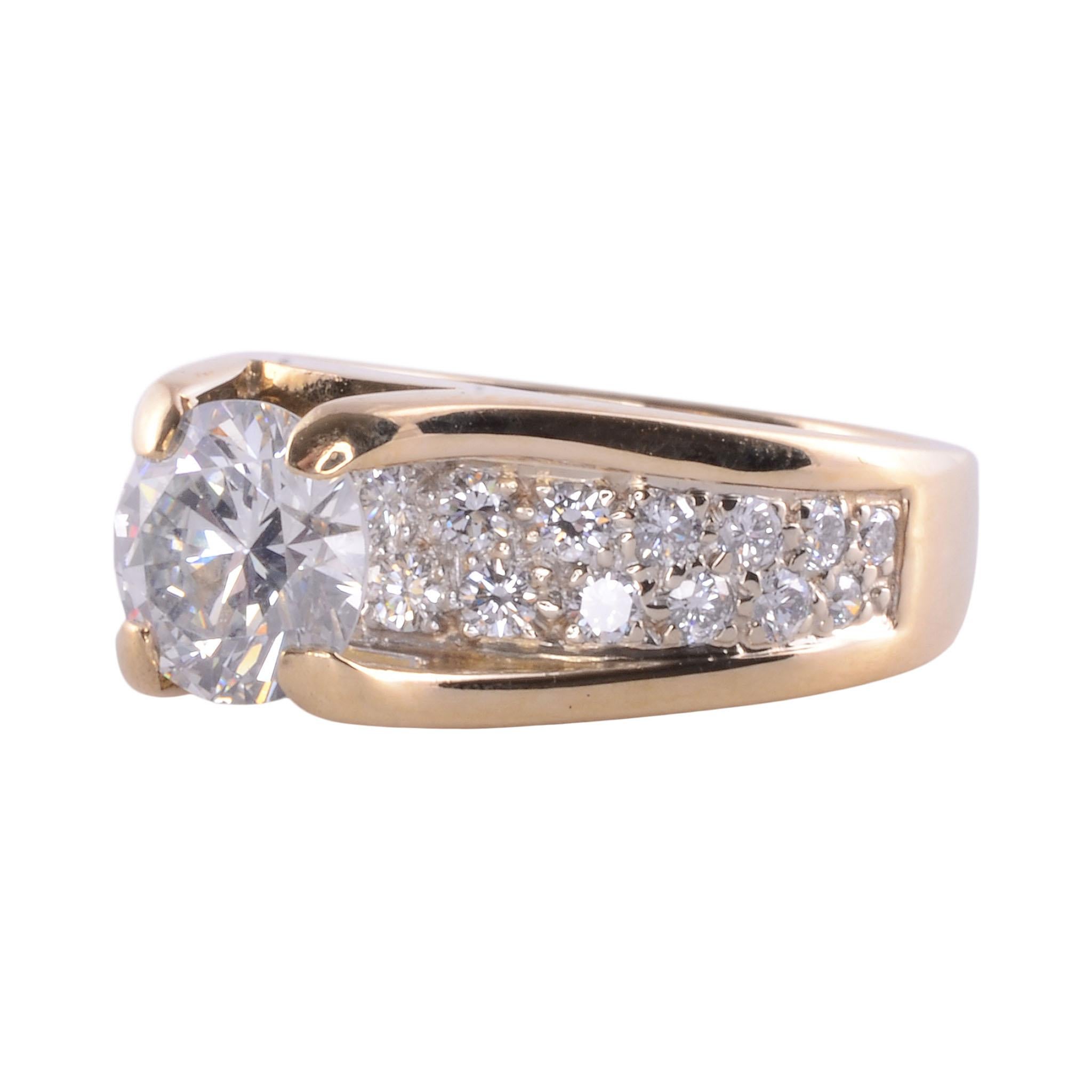 Estate 1.52 carat VS2 center diamond ring. This two tone 14 karat gold ring features a 1.52 carat center diamond with VS2 clarity and G color. There are also 26 full cut diamonds at .50 carat total weight. The pave set accent diamonds have VS1-2