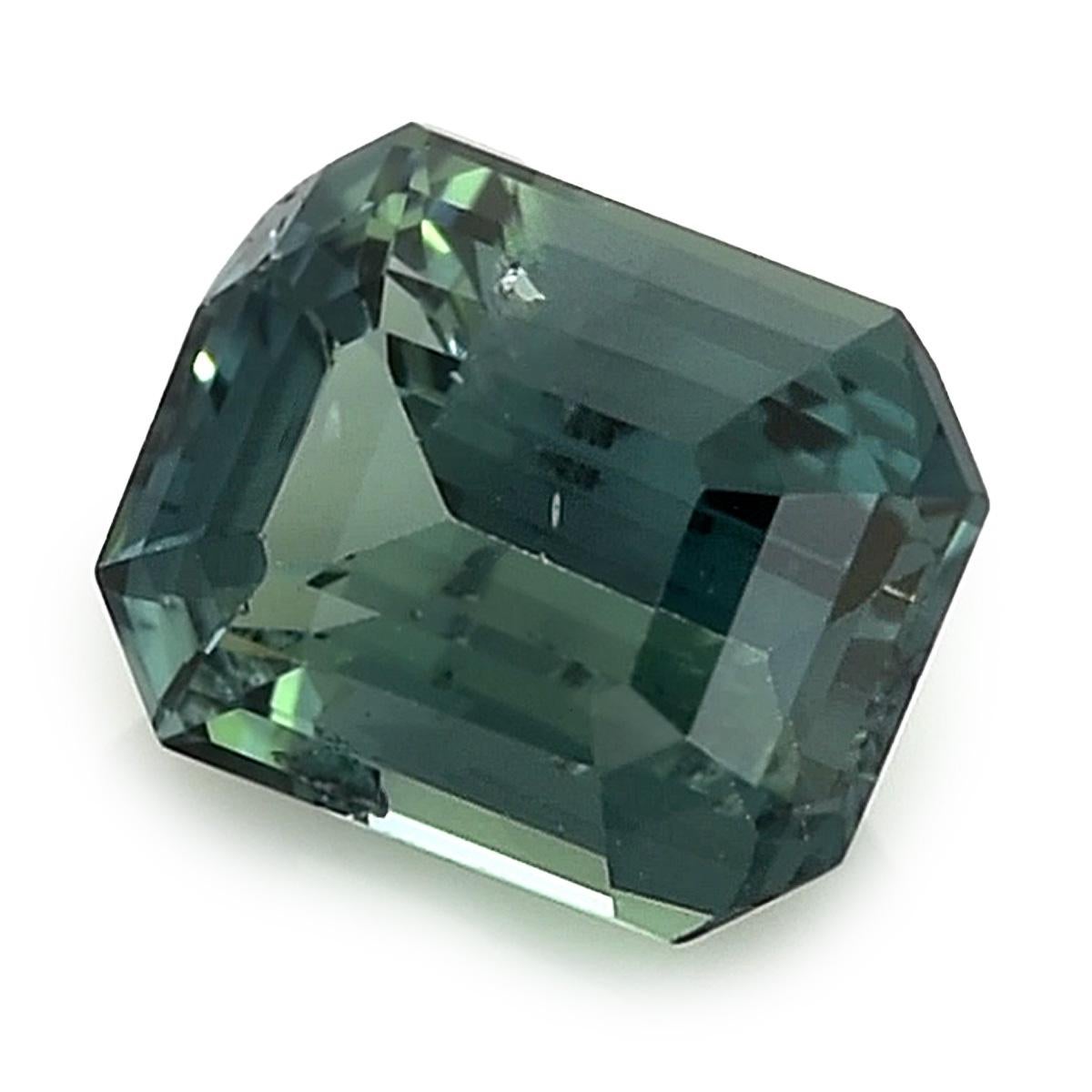 Presenting a Natural Green Blue Sapphire, distinguished by its weight of 1.52 carats. This alluring gem showcases an Emerald shape with precise dimensions measuring 7.08 x 5.55 x 3.89 mm. The Brilliant/Step cut enhances its radiance, unveiling a