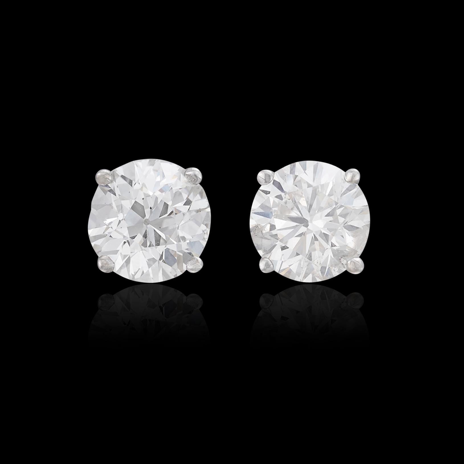 Sparkling diamond stud earrings are a must for any collection! Set in 14k white gold, the two round brilliant-cut diamonds weigh approximately 1.52 carats and have been graded  I/VS-SI. The studs weigh 1.1 grams. Brilliant and eye-catching, these