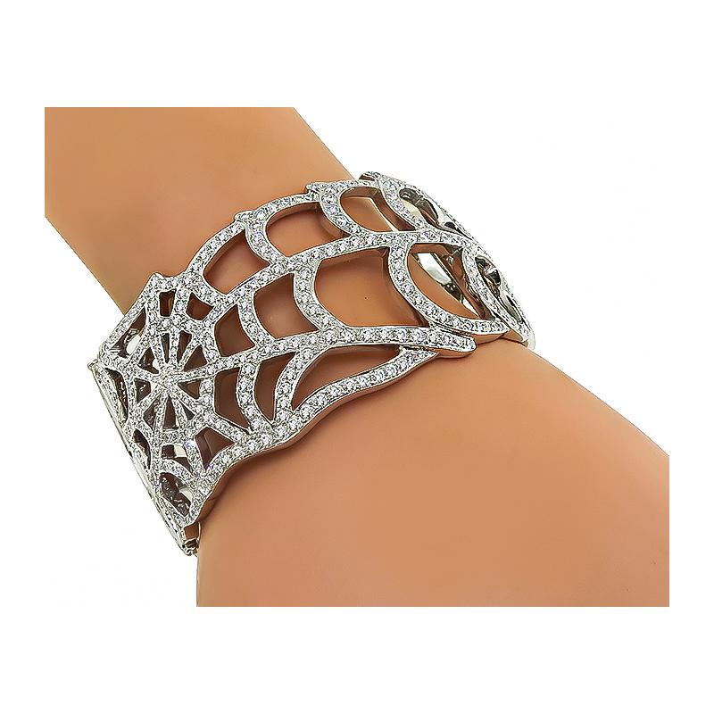 This is a stunning 18k white gold bangle. The bangle is set with sparkling round cut diamonds that weigh 15.20ct. The color of these diamonds is G-H with VS clarity. The bangle measures 35mm in width and will fit a standard wrist size. The bangle is