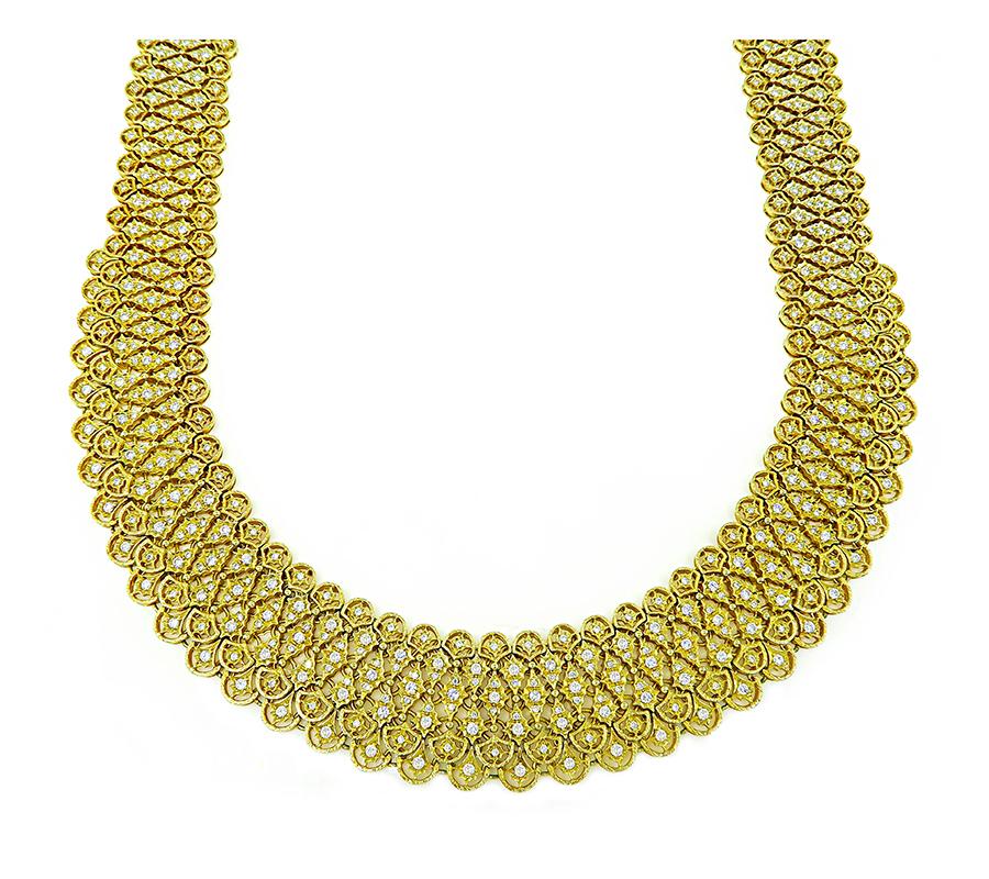 This is a fabulous 18k yellow gold choker necklace. The necklace features sparkling round cut diamonds that weigh approximately 15.20ct. The color of these diamonds is G-H with VS clarity. The necklace measures 26mm in width at the widest base and