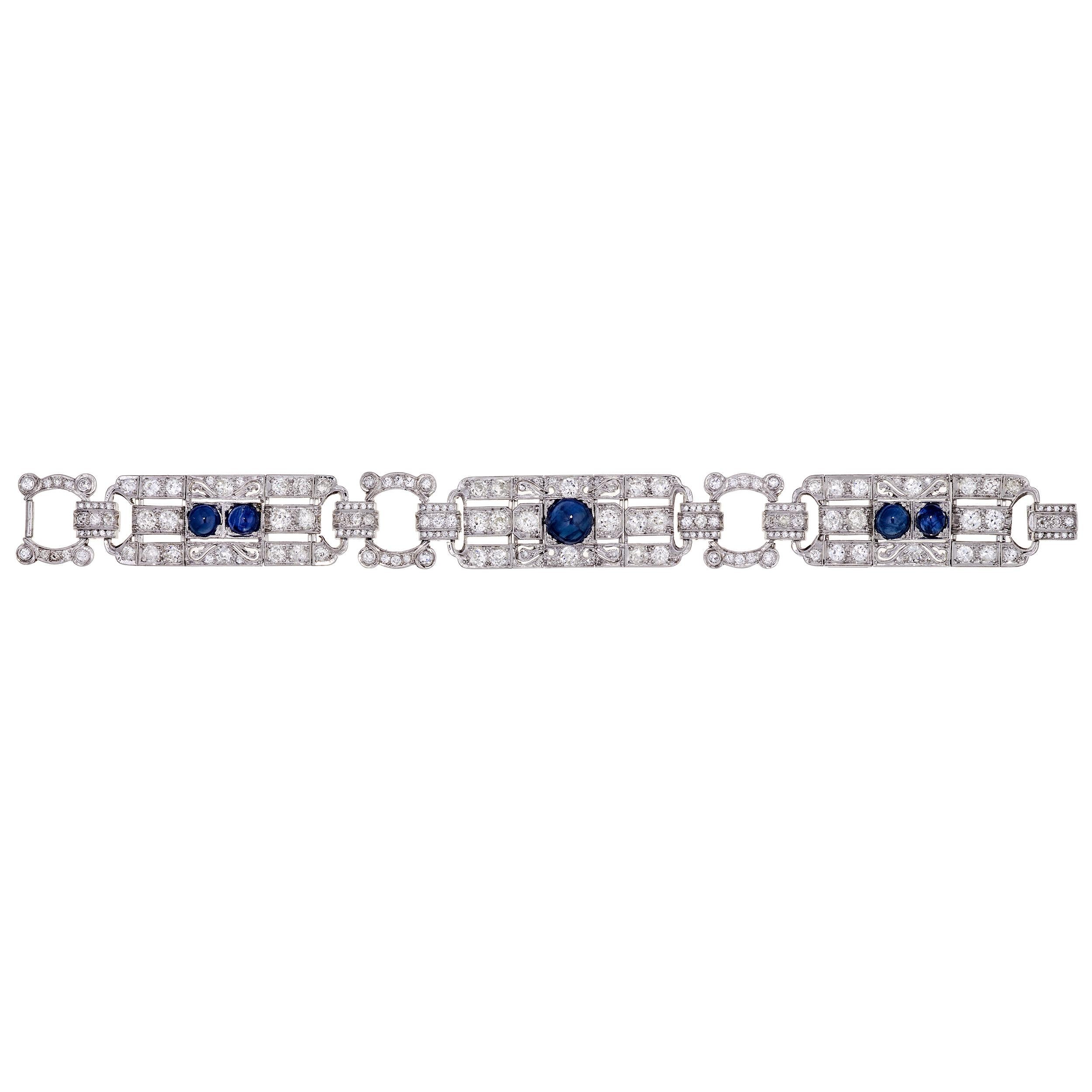 A gorgeous example of classic Art Deco work.  This stunning bracelet works just as well with jeans as it does with an evening gown.  This bracelet features 3 large sections, the center section featuring a single large round Sapphire Cabochon, and