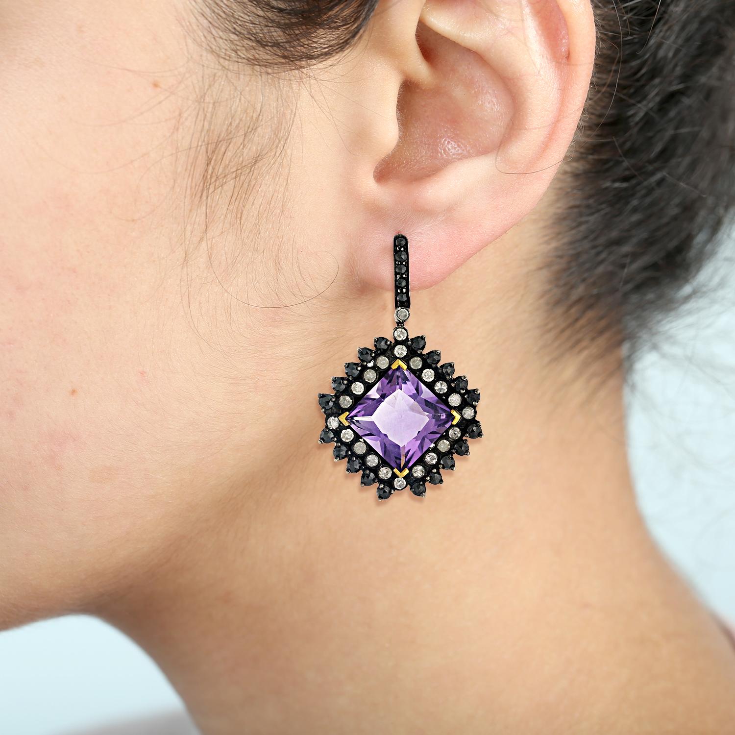 15.25cts Amethyst drop earring with Black and White Diamond in silver and gold is cool and very attractive.

Closure: Push Post

18kt gold: 1.98gms
Diamond: 3.74cts
Silver: 11.52gms
Amethyst: 15.25cts
