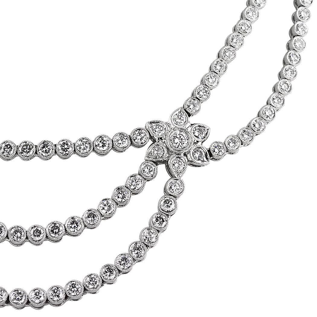 Elegant and sophisticated, this one of a kind layered diamond necklace showcases 15.27ct of round brilliant cut diamonds bezel set in an intricate floral pattern. All of the diamonds are graded at E-F, VS2-SI2 and hand set in platinum.