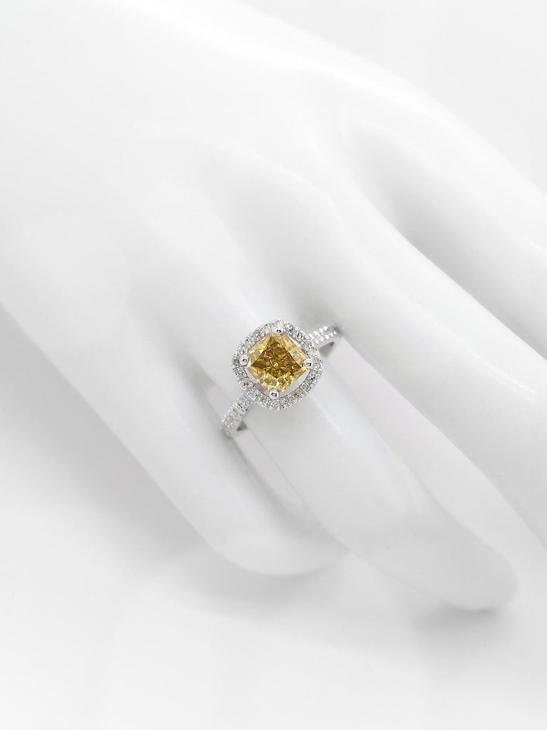 In this elegant and classy 14kt white gold ring, 1.52 carat fancy greenish yellow diamond ring is surrounded by 38 natural round brilliant diamonds totaling 0.35 carats round brilliant diamonds and creating a very gentle and sparkly