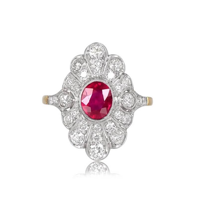 An Art Deco-inspired ring boasting a 1.52-carat oval-cut ruby bezel-set and encircled by pave-set diamonds in a geometric pattern. Two accent diamonds are bezel-set on either side of the ruby, with the shoulders adorned in pave-set smaller stones.