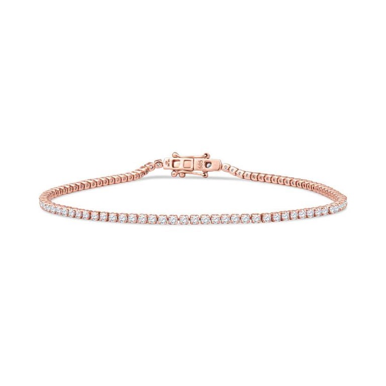 This dainty diamond tennis bracelet features 1.52ct total weight in round brilliant cut diamonds, set in 14kt yellow gold. The bracelet is a size 7, perfect for layering with other bracelets or to wear on its own. This bracelet also comes in white